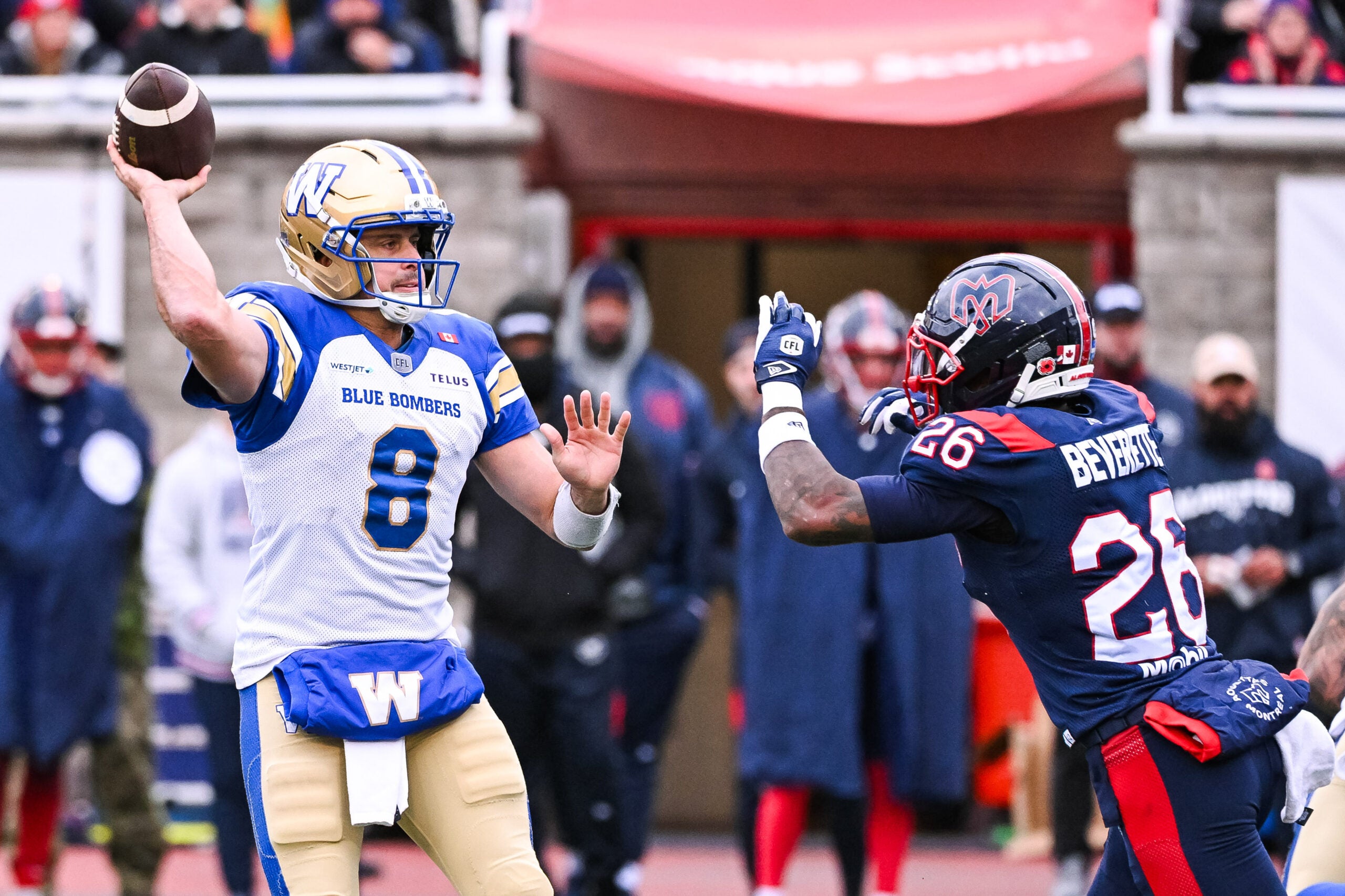Nov 1, 2025; Montreal, Quebec, Canada; Winnipeg Blue Bombers quarterback Zach Collaros (8) passes the ball as Montreal Alouettes line backer Tyrice Beverette (26) closes in during the third quarter at Percival-Molson stadium.