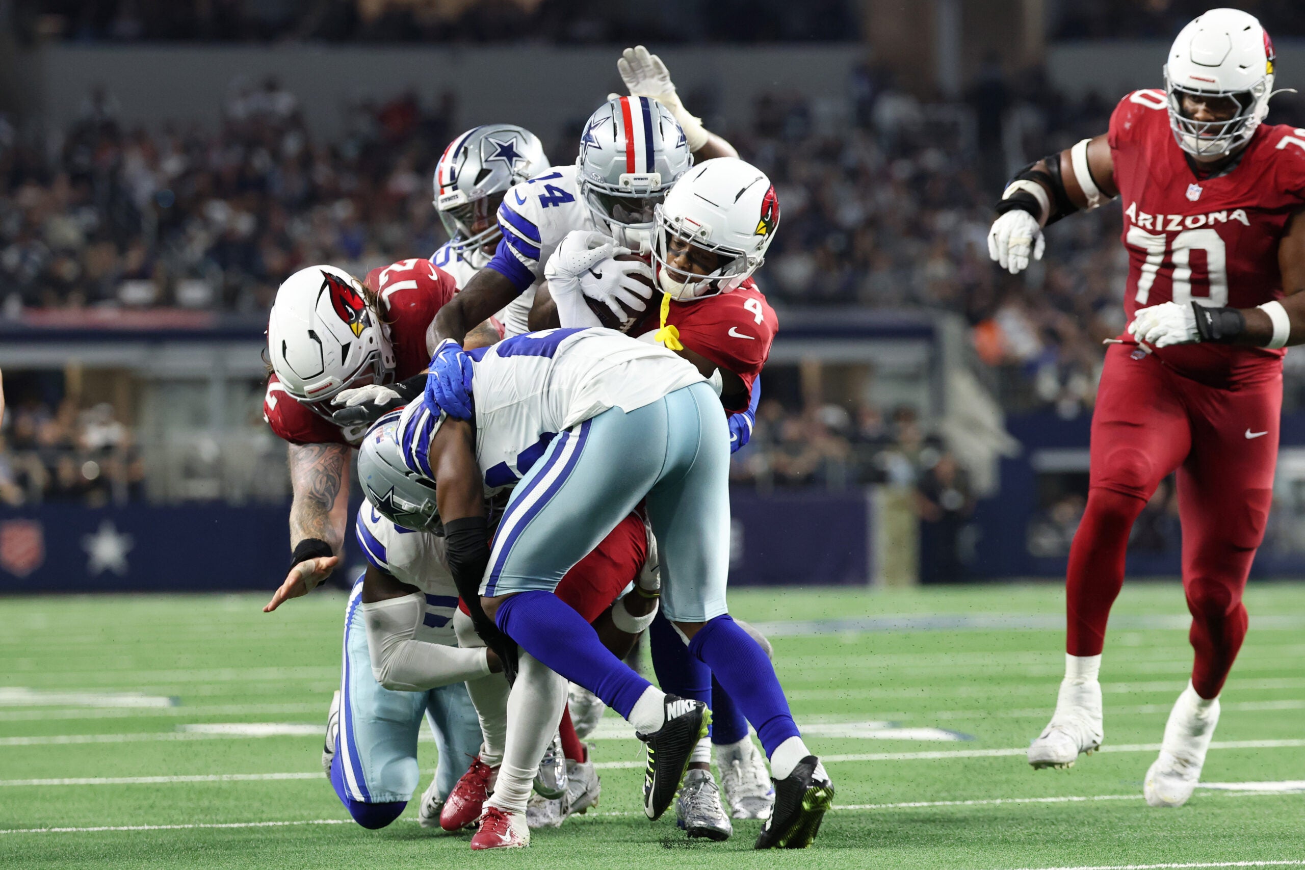 Nov 3, 2025; Arlington, Texas, USA; Arizona Cardinals wide receiver Greg Dortch (4) runs against Dallas Cowboys safety Markquese Bell (14) in the first half at AT&T Stadium.