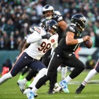 Nov 28, 2025; Philadelphia, Pennsylvania, USA; Philadelphia Eagles quarterback Jalen Hurts (1) scrambles with the ball defended by Chicago Bears defensive end Montez Sweat (98) during the first quarter of the game at Lincoln Financial Field.