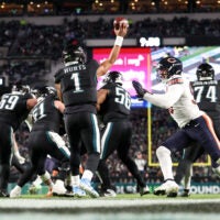 Nov 28, 2025; Philadelphia, Pennsylvania, USA; Philadelphia Eagles quarterback Jalen Hurts (1) passes the ball under pressure by Chicago Bears defensive end Montez Sweat (98) during the third quarter of the game at Lincoln Financial Field.