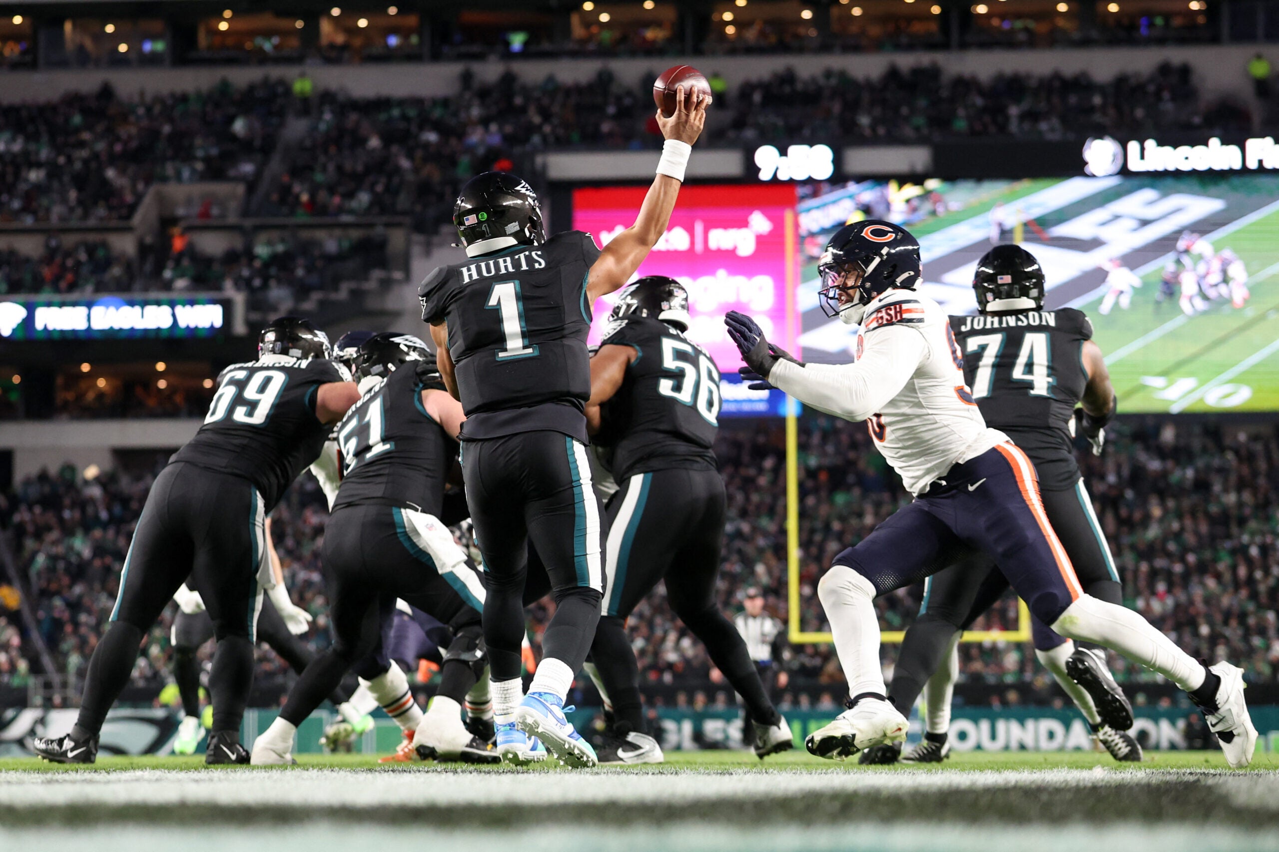 Nov 28, 2025; Philadelphia, Pennsylvania, USA; Philadelphia Eagles quarterback Jalen Hurts (1) passes the ball under pressure by Chicago Bears defensive end Montez Sweat (98) during the third quarter of the game at Lincoln Financial Field.