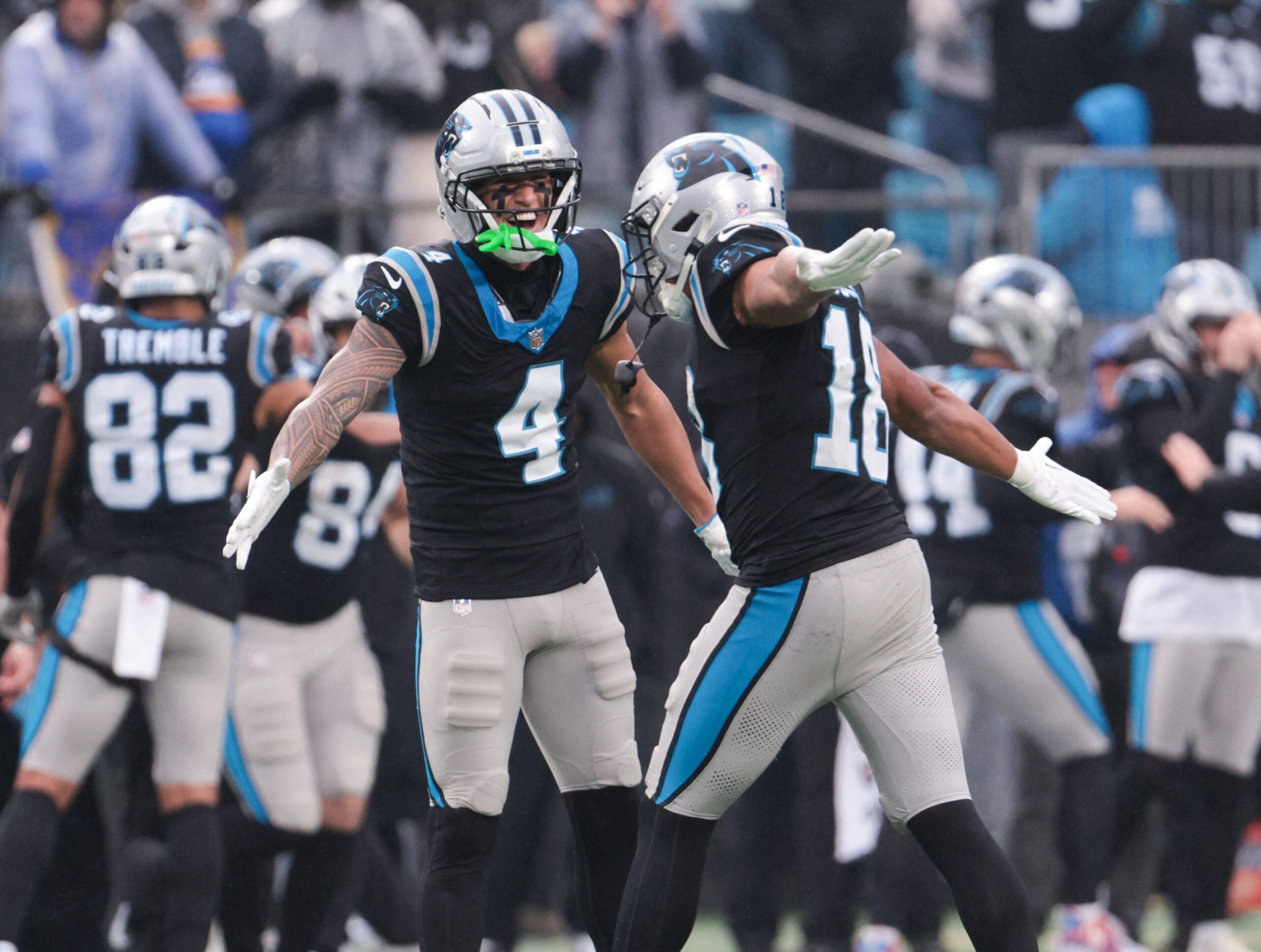 Nov 30, 2025; Charlotte, North Carolina, USA; Carolina Panthers wide receiver Tetairoa McMillan (4) celebrates with Carolina Panthers wide receiver Jalen Coker (18) after a play during the fourth quarter against the Los Angeles Rams at Bank of America Stadium.