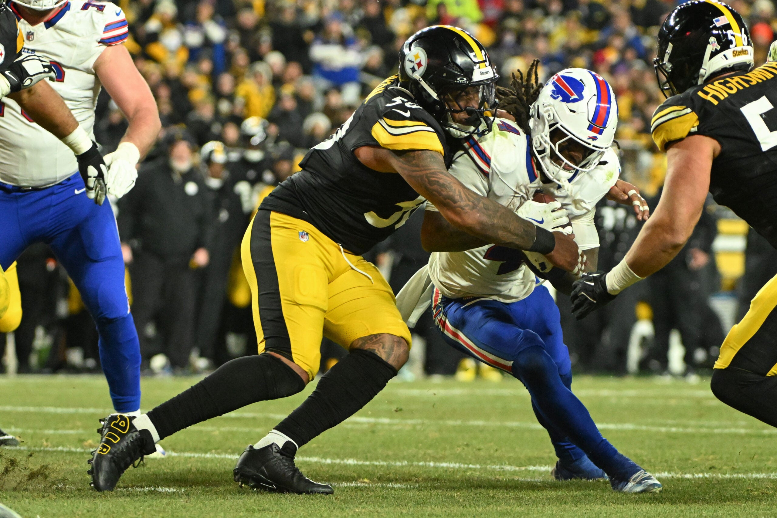 Nov 30, 2025; Pittsburgh, Pennsylvania, USA; Pittsburgh Steelers linebacker Malik Harrison (50) tackles Buffalo Bills running back James Cook III (4) during the second half at Acrisure Stadium.
