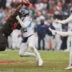 Dec 7, 2025; Cleveland, Ohio, USA; Tennessee Titans punter Johnny Hekker (3) punts the ball against Cleveland Browns defensive tackle Sam Kamara (92) during the second quarter at Huntington Bank Field.