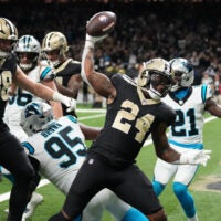 Dec 14, 2025; New Orleans, Louisiana, USA; New Orleans Saints running back Devin Neal (24) reacts after scoring a touchdown during the second quarter against the Carolina Panthers at Caesars Superdome.