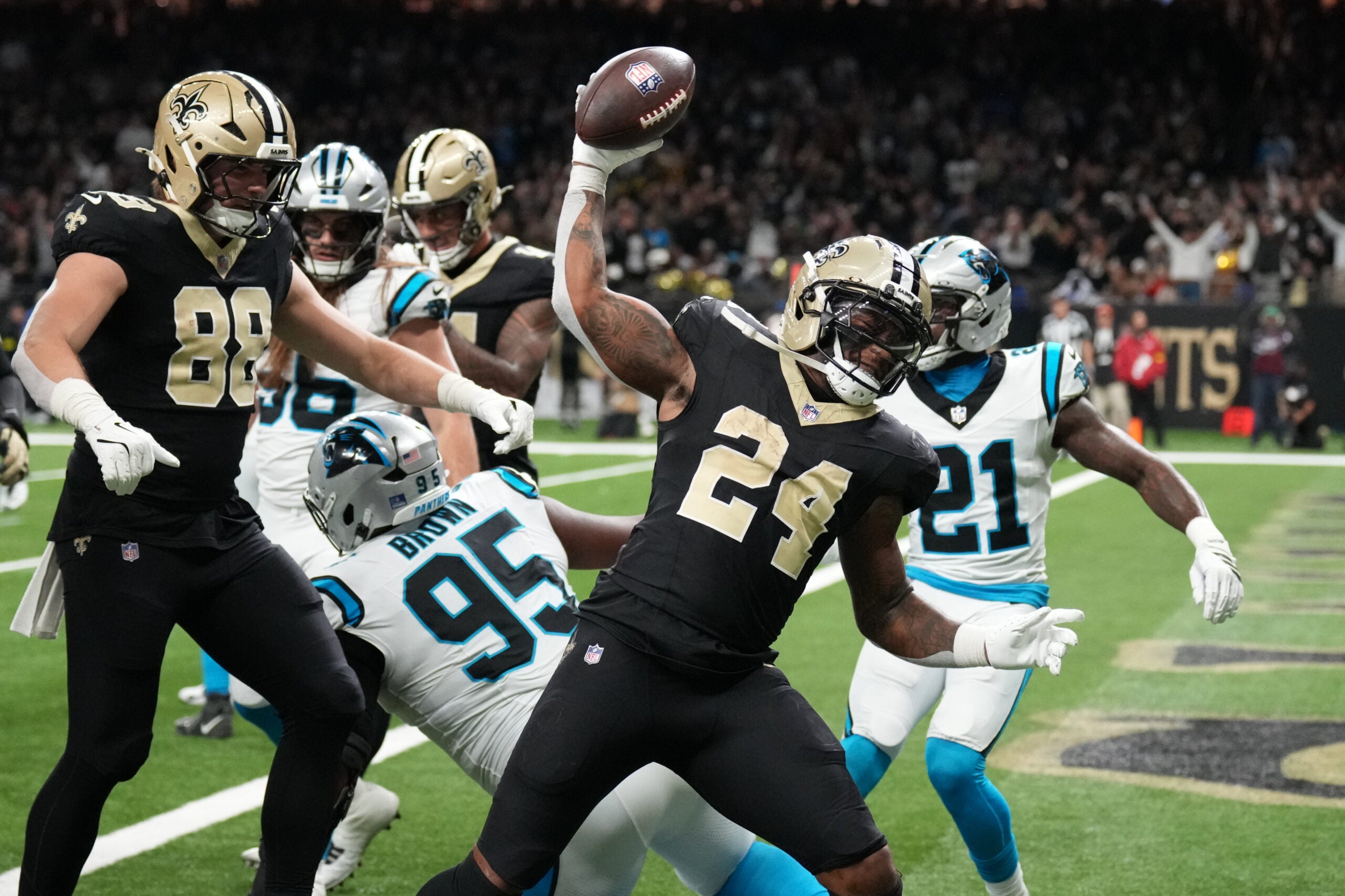 Dec 14, 2025; New Orleans, Louisiana, USA; New Orleans Saints running back Devin Neal (24) reacts after scoring a touchdown during the second quarter against the Carolina Panthers at Caesars Superdome.