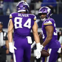 Dec 14, 2025; Arlington, Texas, USA; Minnesota Vikings fullback C.J. Ham (30) celebrates with tight end Josh Oliver (84) after scoring a touchdown during the second half against the Dallas Cowboys at AT&T Stadium.
