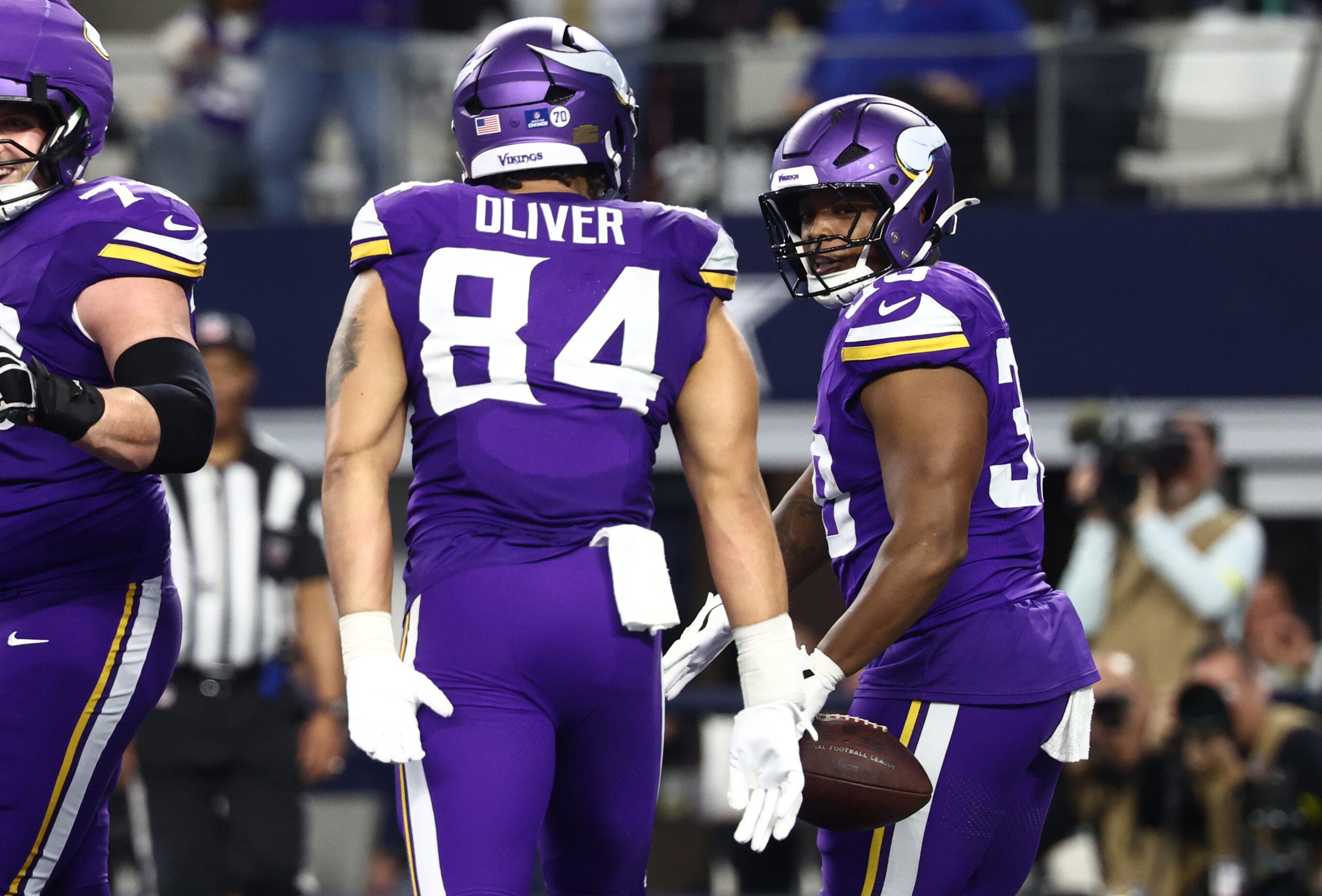 Dec 14, 2025; Arlington, Texas, USA; Minnesota Vikings fullback C.J. Ham (30) celebrates with tight end Josh Oliver (84) after scoring a touchdown during the second half against the Dallas Cowboys at AT&T Stadium.
