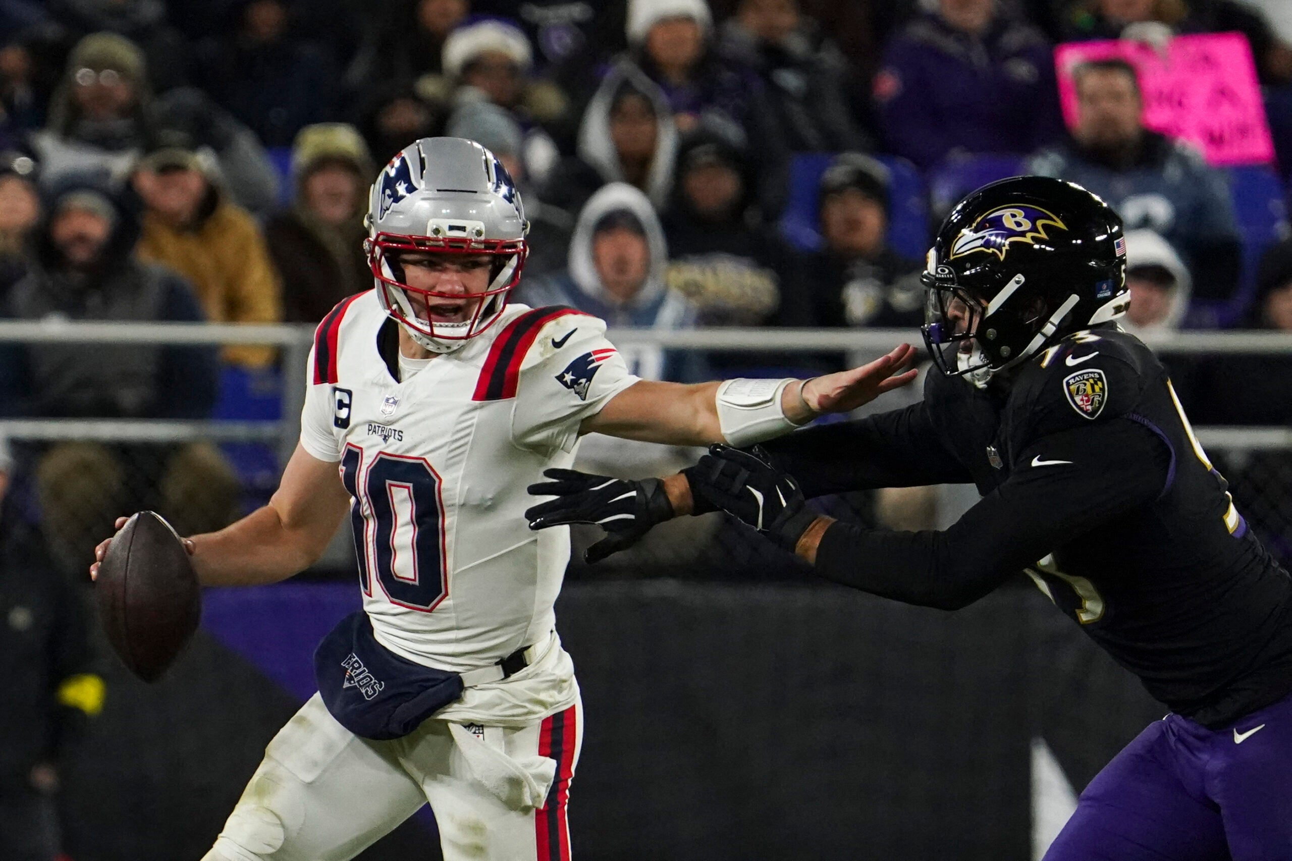 Dec 21, 2025; Baltimore, Maryland, USA; New England Patriots quarterback Drake Maye (10) runs from Baltimore Ravens linebacker Kyle van Noy (53) during the first half of the game at M&T Bank Stadium.