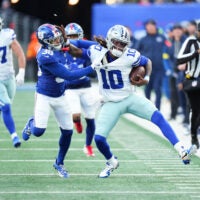 Jan 4, 2026; East Rutherford, New Jersey, USA; Dallas Cowboys quarterback Joe Milton III (10) scrambles and is tackled by New York Giants cornerback Rico Payton (36) during the fourth quarter at MetLife Stadium.