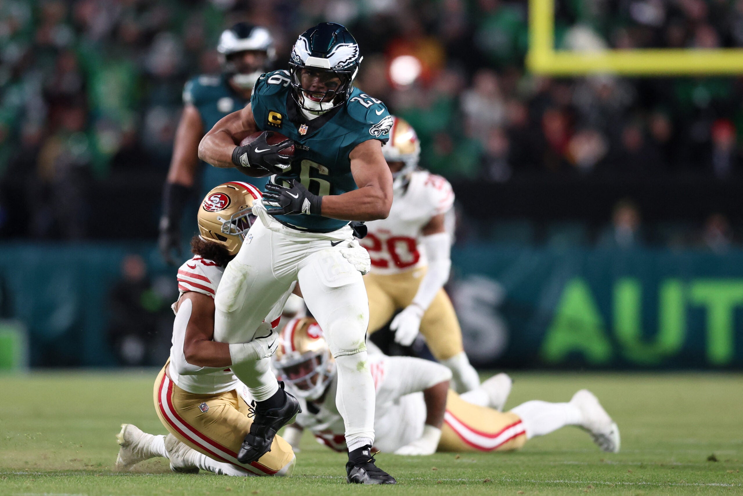 Jan 11, 2026; Philadelphia, PA, USA; San Francisco 49ers linebacker Eric Kendricks (43) tackles Philadelphia Eagles running back Saquon Barkley (26) during the second quarter in an NFC Wild Card Round game at Lincoln Financial Field.