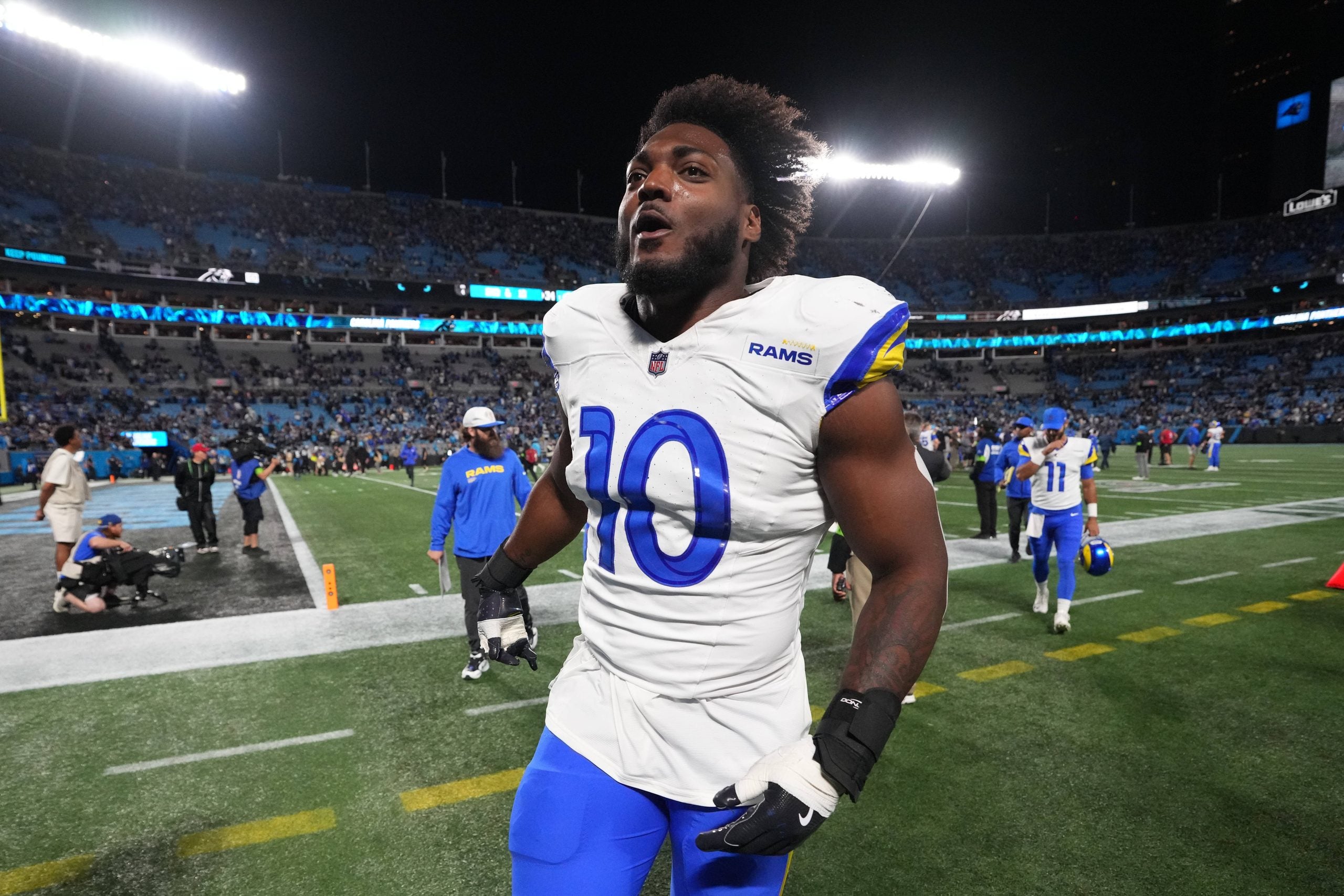 Jan 10, 2026; Charlotte, NC, USA; Los Angeles Rams outside linbacker Josaiah Stewart (10) runa off the field after the NFC Wild Card Round game at Bank of America Stadium.