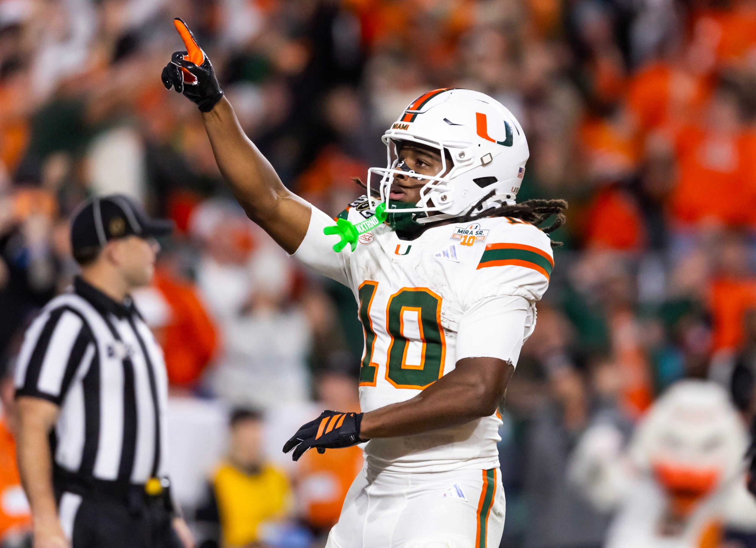 Jan 19, 2026; Miami Gardens, FL, USA; Miami Hurricanes wide receiver Malachi Toney (10) celebrates after scoring a touchdown against the Indiana Hoosiers during the College Football Playoff National Championship game at Hard Rock Stadium.