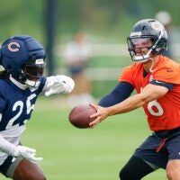 Aug 5, 2026; Lake Forest, IL, USA; Chicago Bears quarterback Caleb Williams (18) passes the ball to running back Kyle Monangai (25) during training camp at Halas Hall.