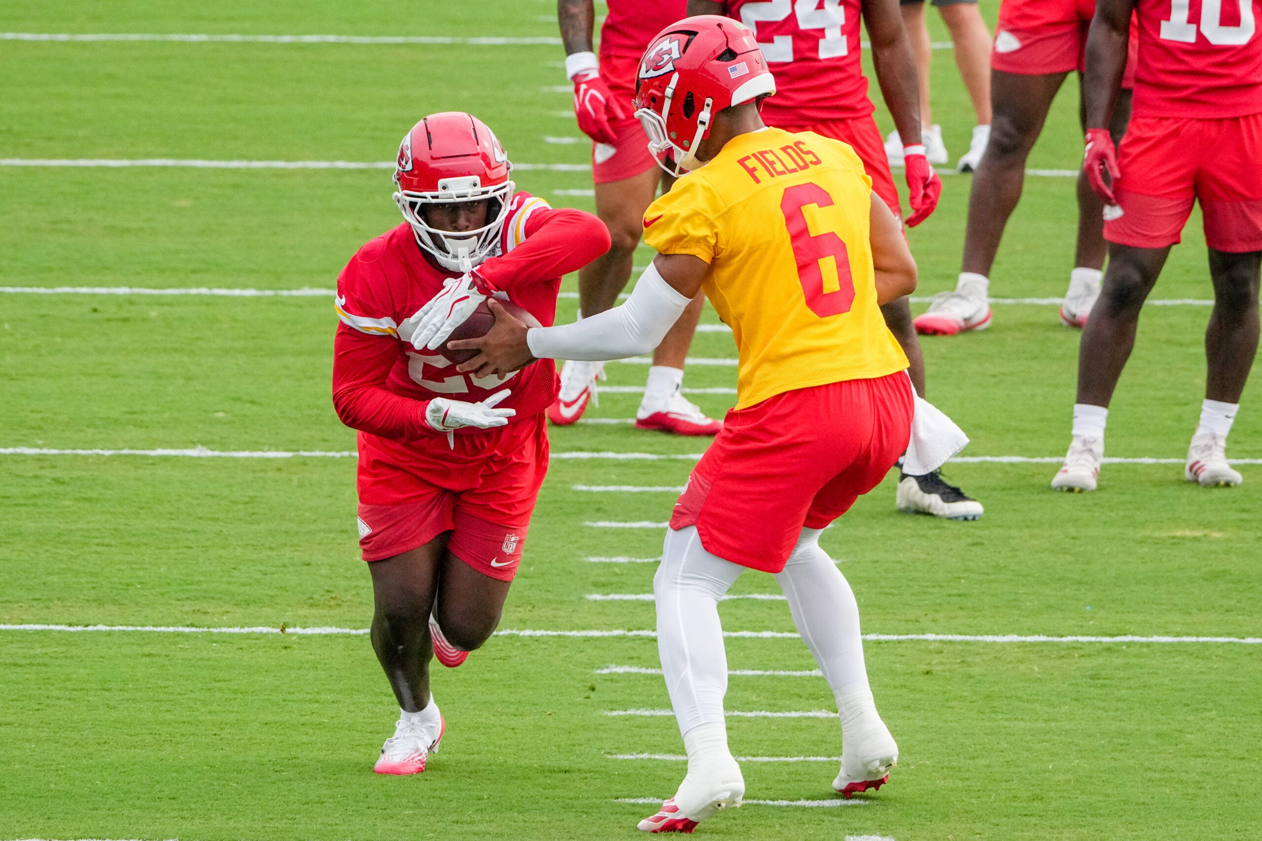 Jul 29, 2026; St. Joseph, MO, USA; Kansas City Chiefs quarterback Justin Fields (6) hands off to running back Emari Demercado (25) during training camp at Missouri Western State University.