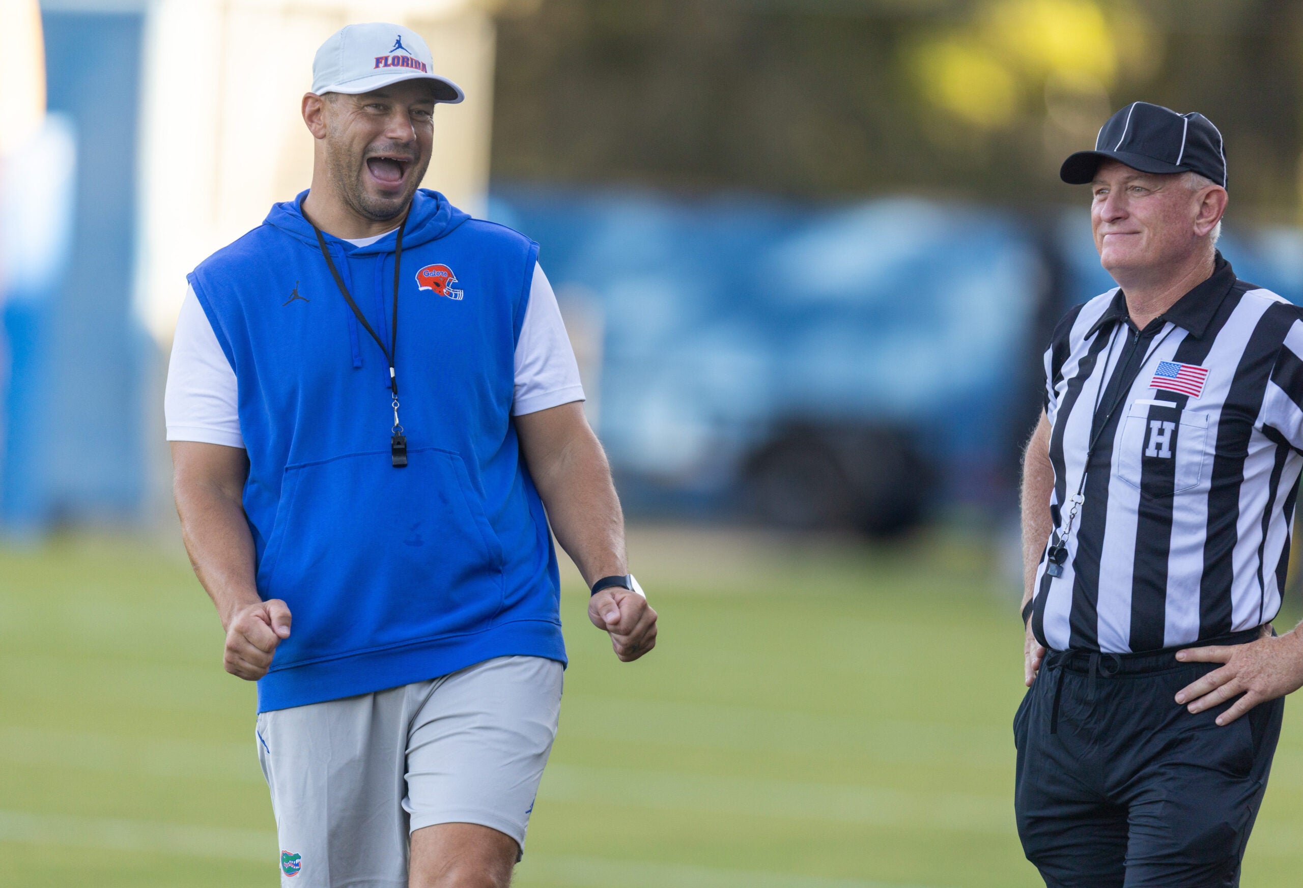 Florida Head Coach Jon Sumrall, left, watches practice with referees at Heavener Football Complex in Gainesville, FL on Tuesday, August 11, 2026.