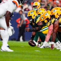 Aug 21, 2026; Denver, Colorado, USA; Green Bay Packers center Jager Burton (52) lines up for a snap in the second quarter of a preseason game against the Denver Broncos at Empower Field at Mile High.