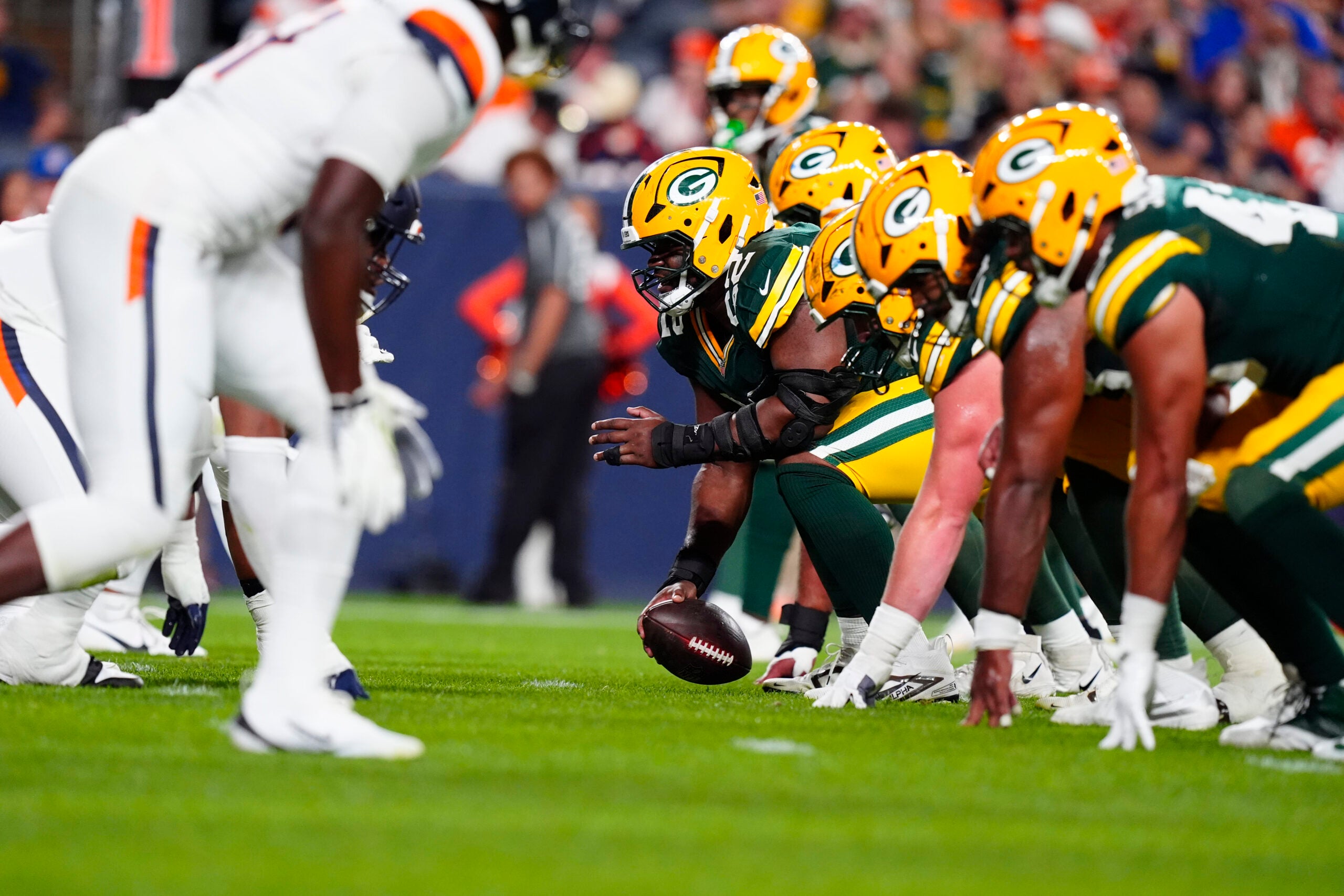 Aug 21, 2026; Denver, Colorado, USA; Green Bay Packers center Jager Burton (52) lines up for a snap in the second quarter of a preseason game against the Denver Broncos at Empower Field at Mile High.