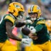 Aug 28, 2026; Green Bay, Wisconsin, USA; Green Bay Packers quarterback Kyle McCord (18) hands the football off to running back Pierre Strong Jr. (22) during the first quarter against the Arizona Cardinals at Lambeau Field.