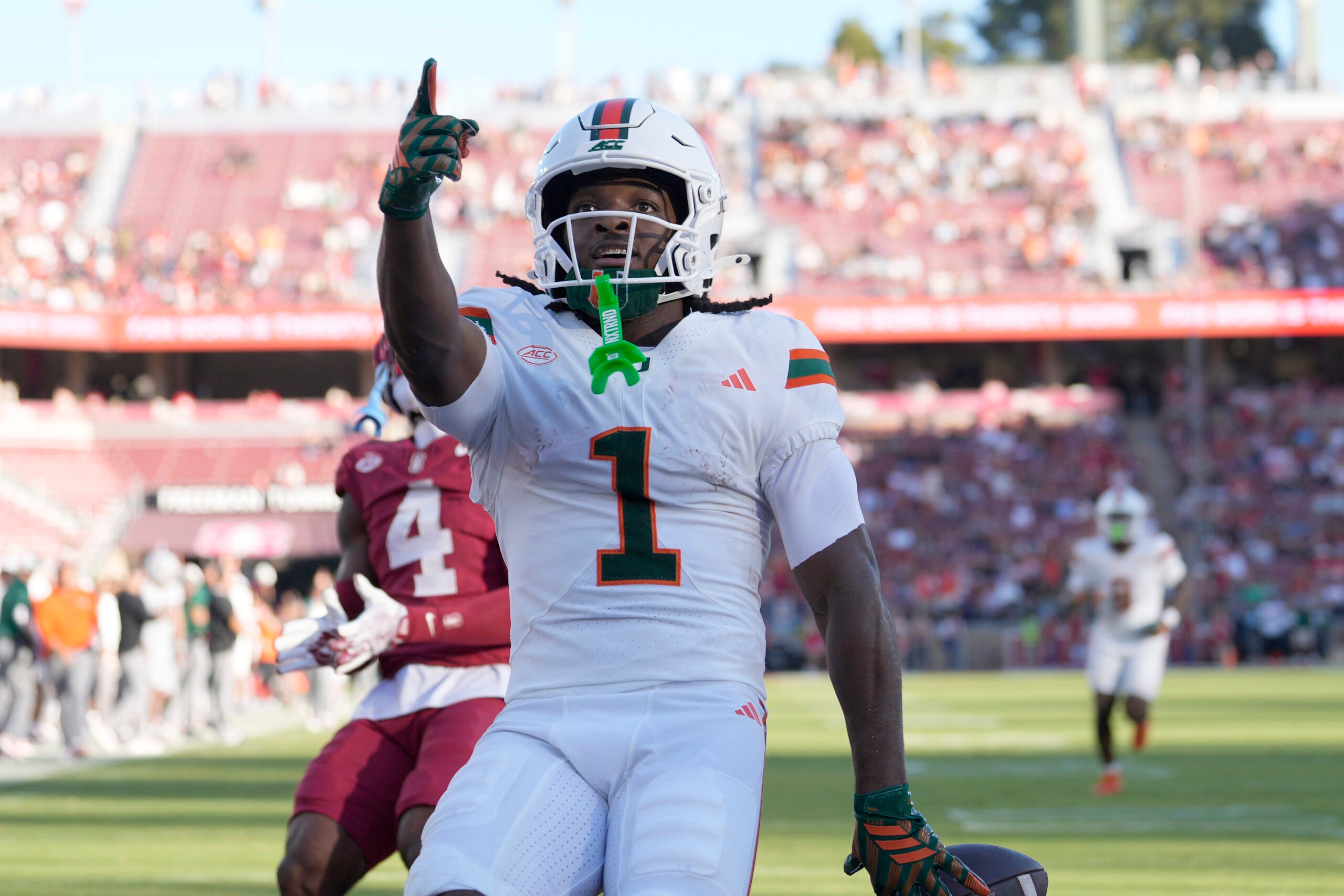 Sep 4, 2026; Stanford, California, USA; Miami Hurricanes wide receiver Malachi Toney (1) reacts after scoring on a touchdown reception against the Stanford Cardinal during the first quarter at Stanford Stadium.