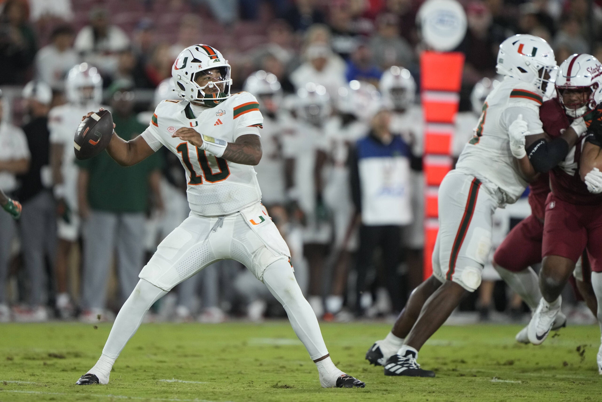 Sep 4, 2026; Stanford, California, USA; Miami Hurricanes quarterback Darian Mensah (10) throws downfield against the Stanford Cardinal during the third quarter at Stanford Stadium.