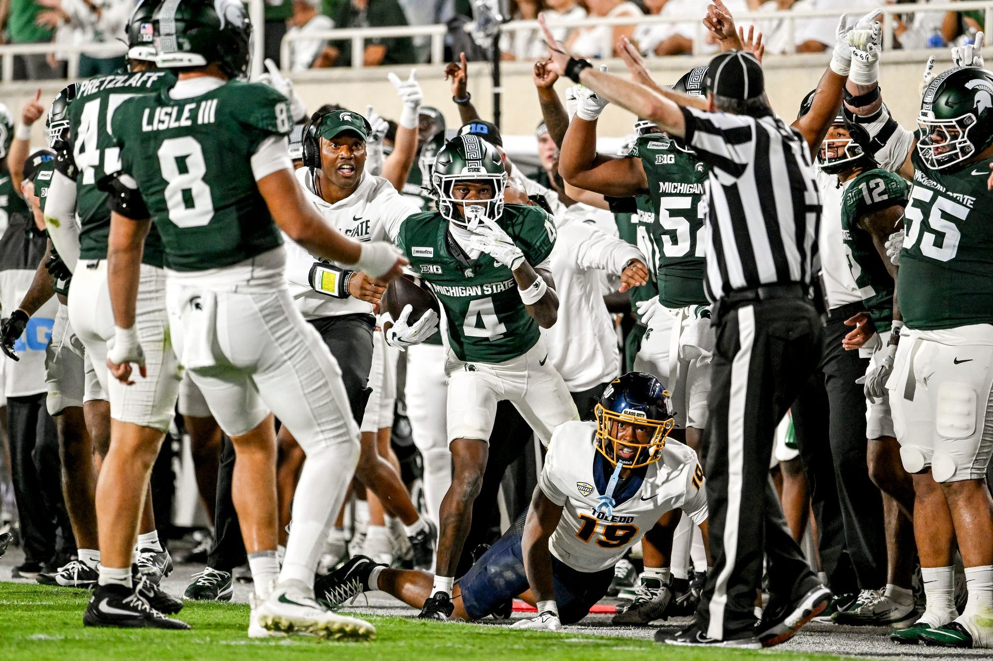 Michigan States Charles Brantley, center, looks to see if referees grant him an interception on a play against Toledos Daryl Barnett Jr. during the second quarter on Friday, Sept. 4, 2026, at Spartan Stadium in East Lansing.