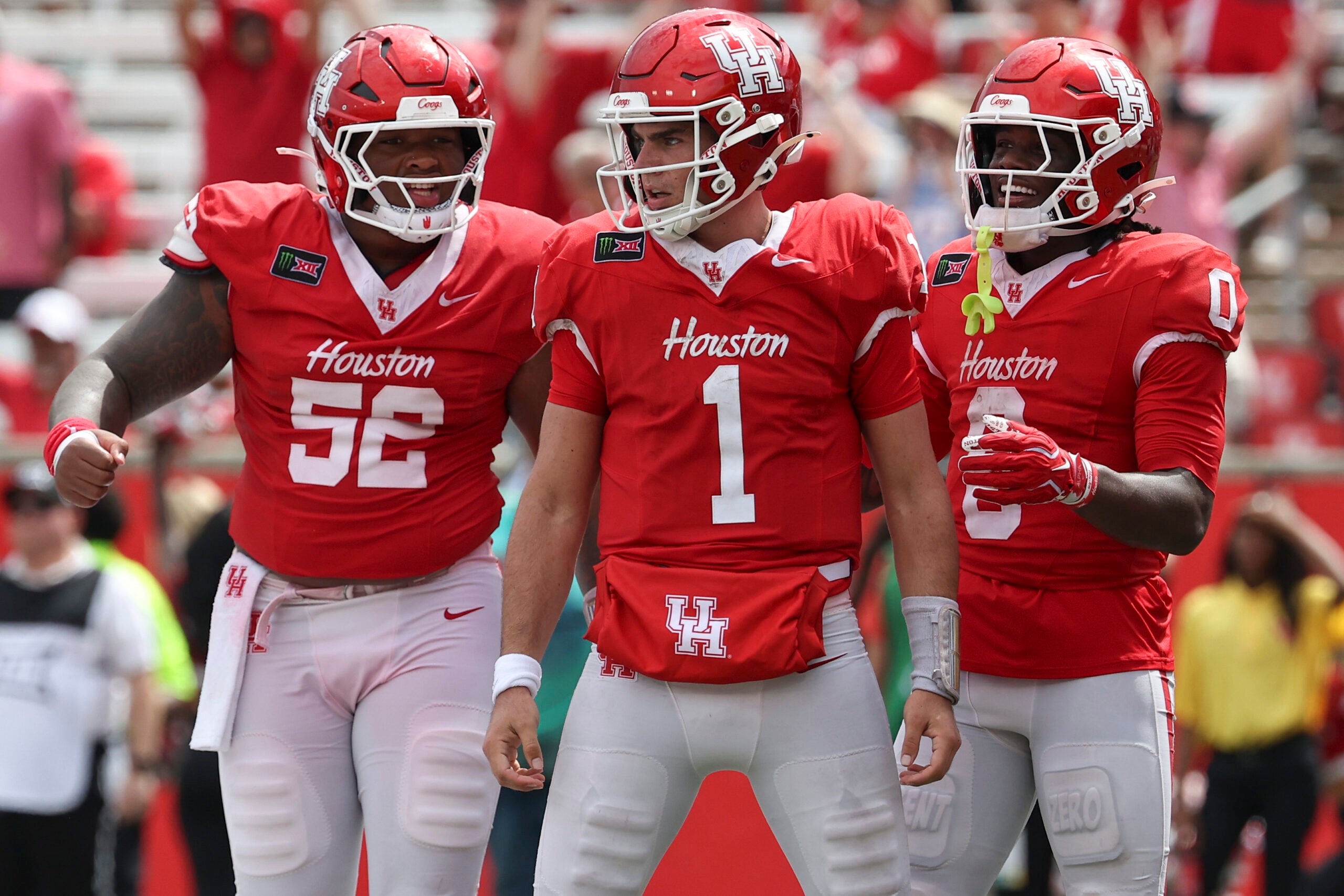 Sep 5, 2026; Houston, Texas, USA; Houston Cougars quarterback Conner Weigman (1) reacts with offensive lineman Anthony Boswell (52) and wide receiver Amare Thomas (0) after a play during the fourth quarter against the Oregon State Beavers at TDECU Stadium.