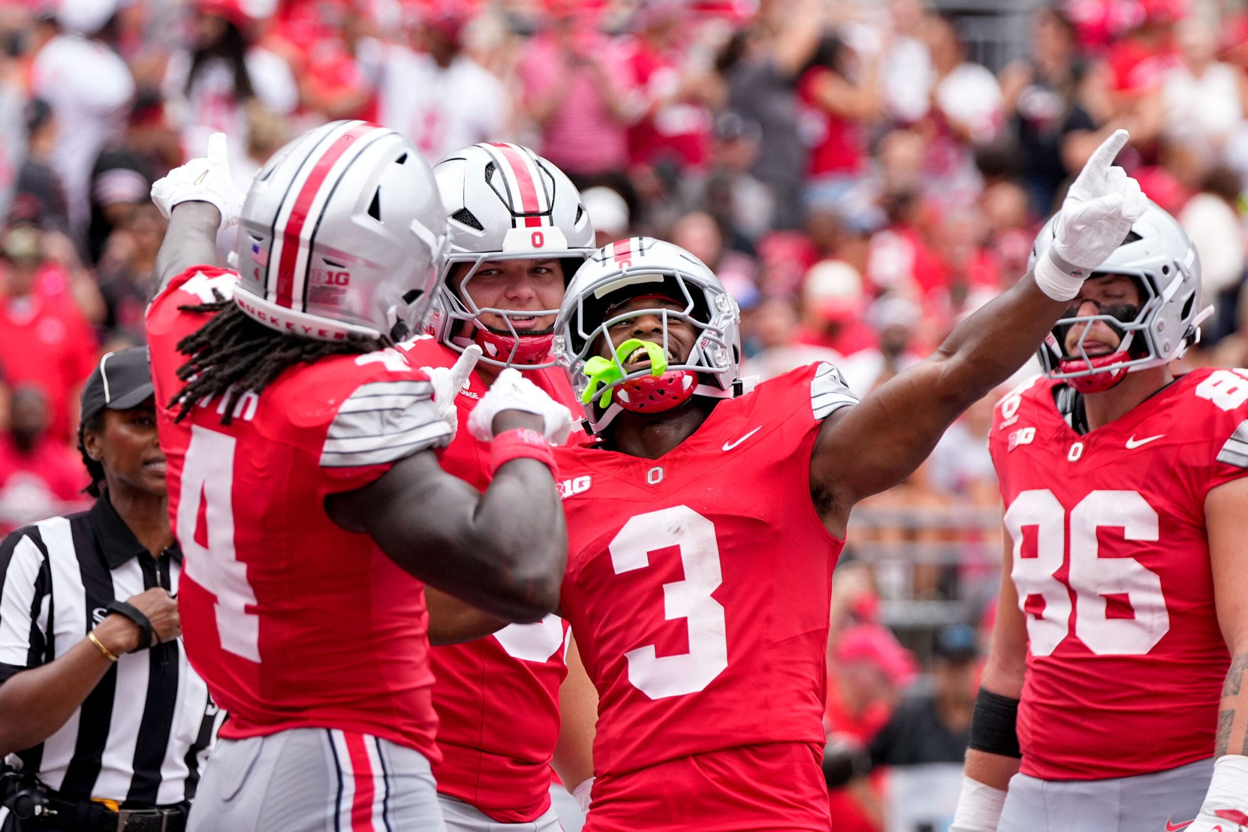 Ohio State Buckeyes wide receiver Devin McCuin (3) celebrates with wide receiver Jeremiah Smith (4) after Smith scored a touchdown in the first half of the NCAA football game at Ohio Stadium on Sept. 5, 2026 in Columbus, Ohio.