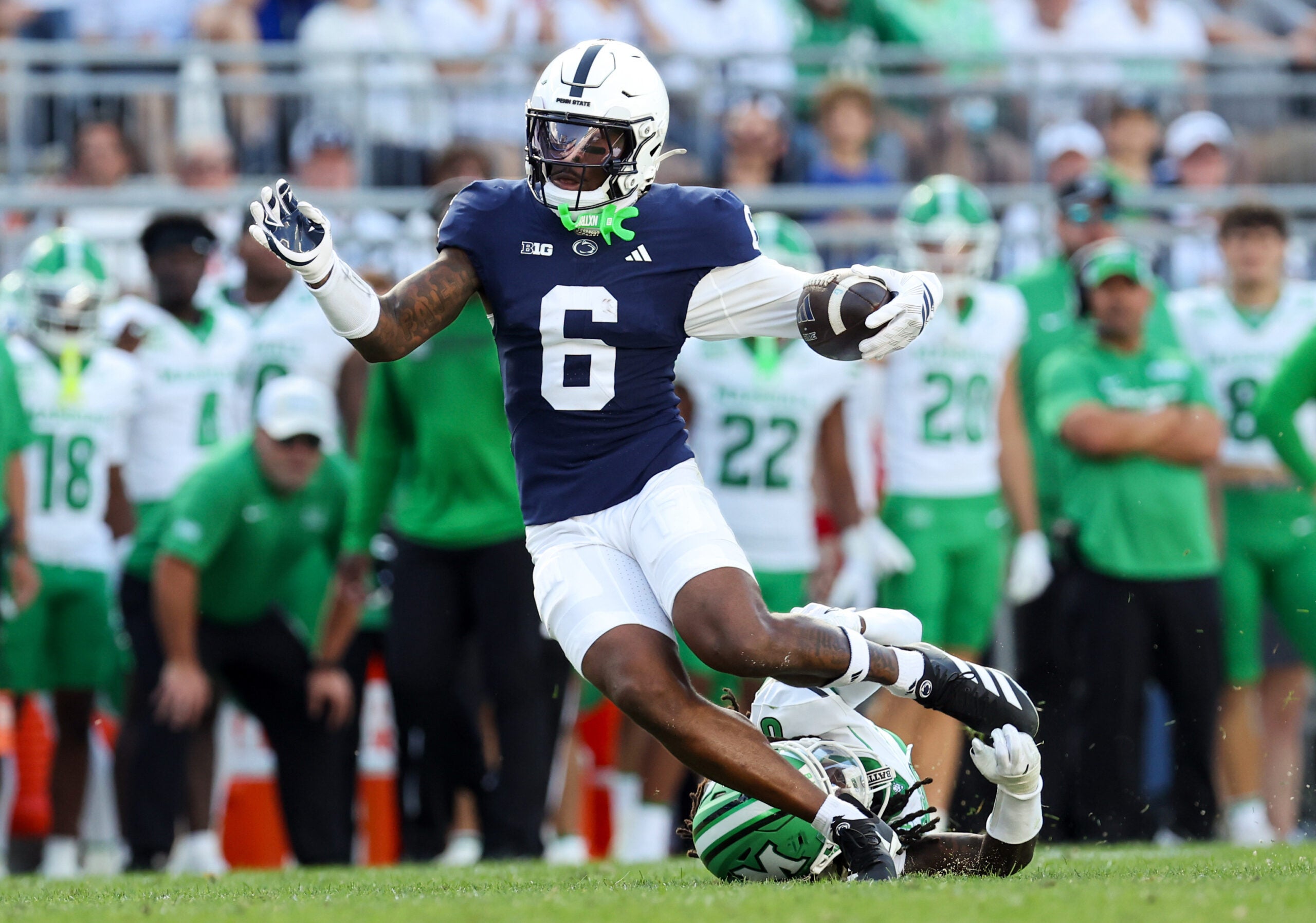 Sep 5, 2026; University Park, Pennsylvania, USA; Penn State Nittany Lions wide receiver Koby Howard (6) runs with the ball while avoiding a tackle from Marshall Thundering Herd defensive back Caleb Clark-Glover (0) during the first quarter at West Shore Home Field at Beaver Stadium.