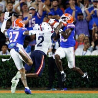 Sep 5, 2026; Gainesville, Florida, USA; Florida Gators safety DJ Coleman (33) intercepts a pass over Florida Atlantic Owls wide receiver Kelby Valsin (2) during the first half at Ben Hill Griffin Stadium.