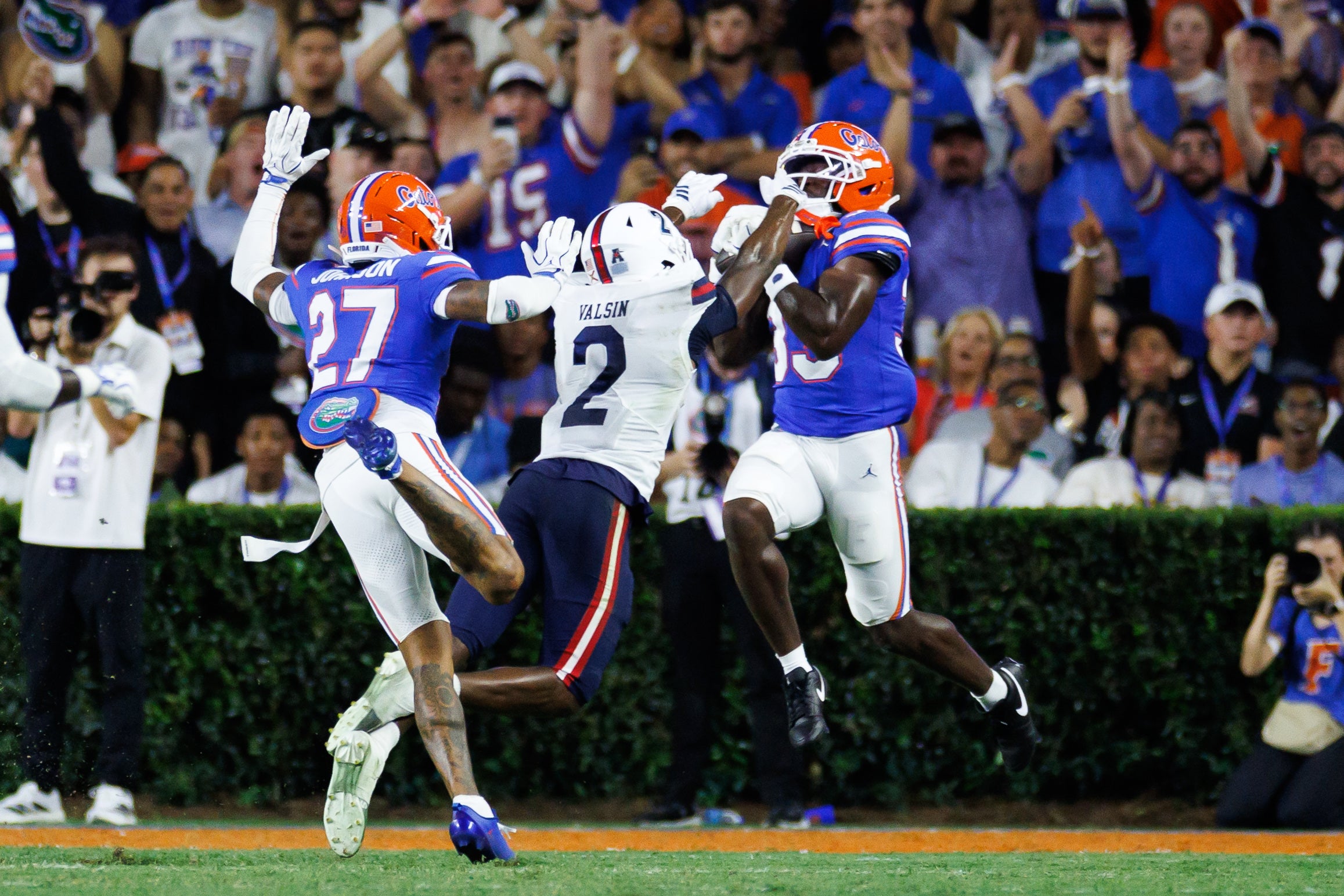 Sep 5, 2026; Gainesville, Florida, USA; Florida Gators safety DJ Coleman (33) intercepts a pass over Florida Atlantic Owls wide receiver Kelby Valsin (2) during the first half at Ben Hill Griffin Stadium.