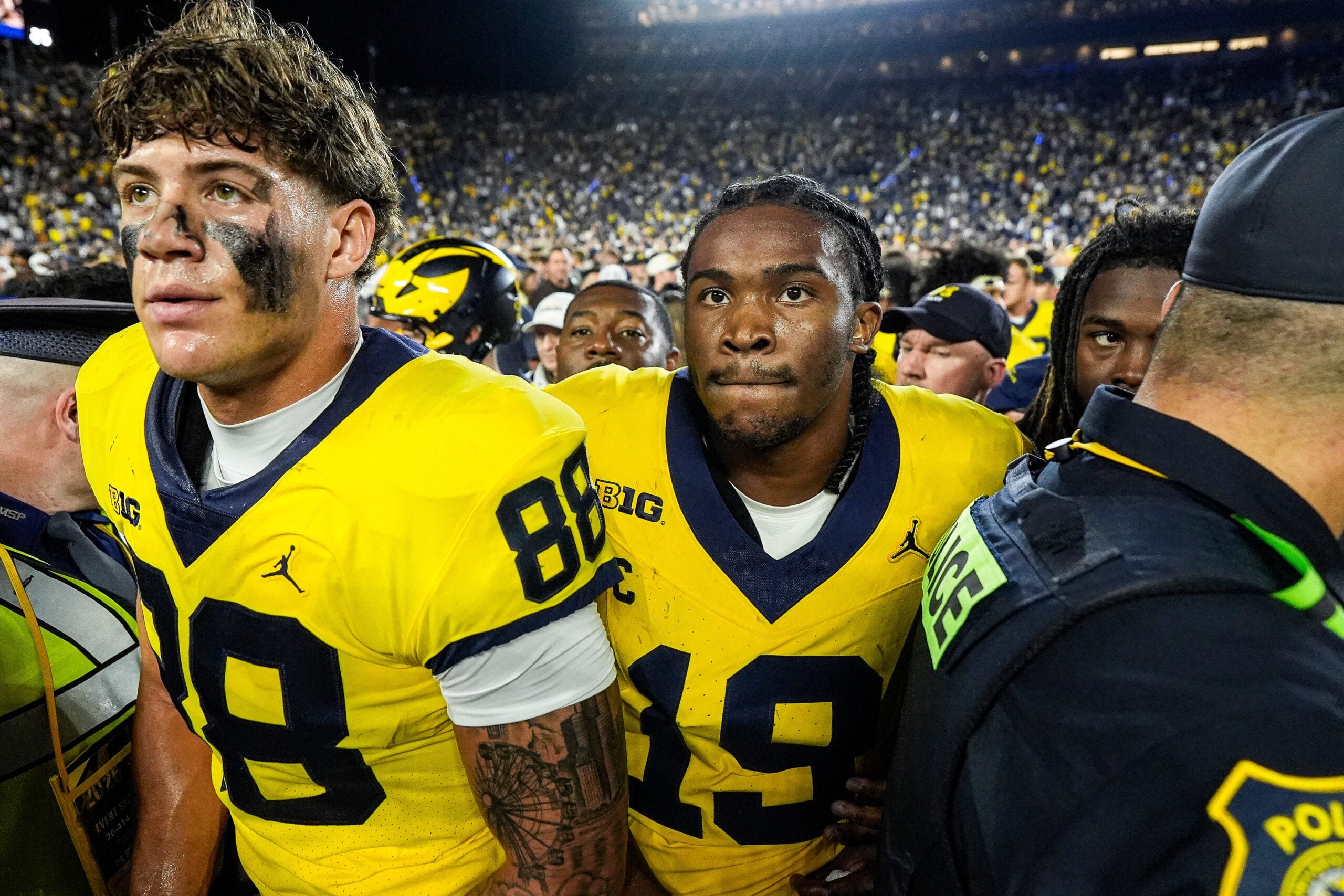 Michigan quarterback Bryce Underwood (19), center, and tight end Deakon Tonielli (88) exit the field after 13-12 win over Western Michigan at Michigan Stadium in Ann Arbor on Saturday, Sept. 5, 2026.