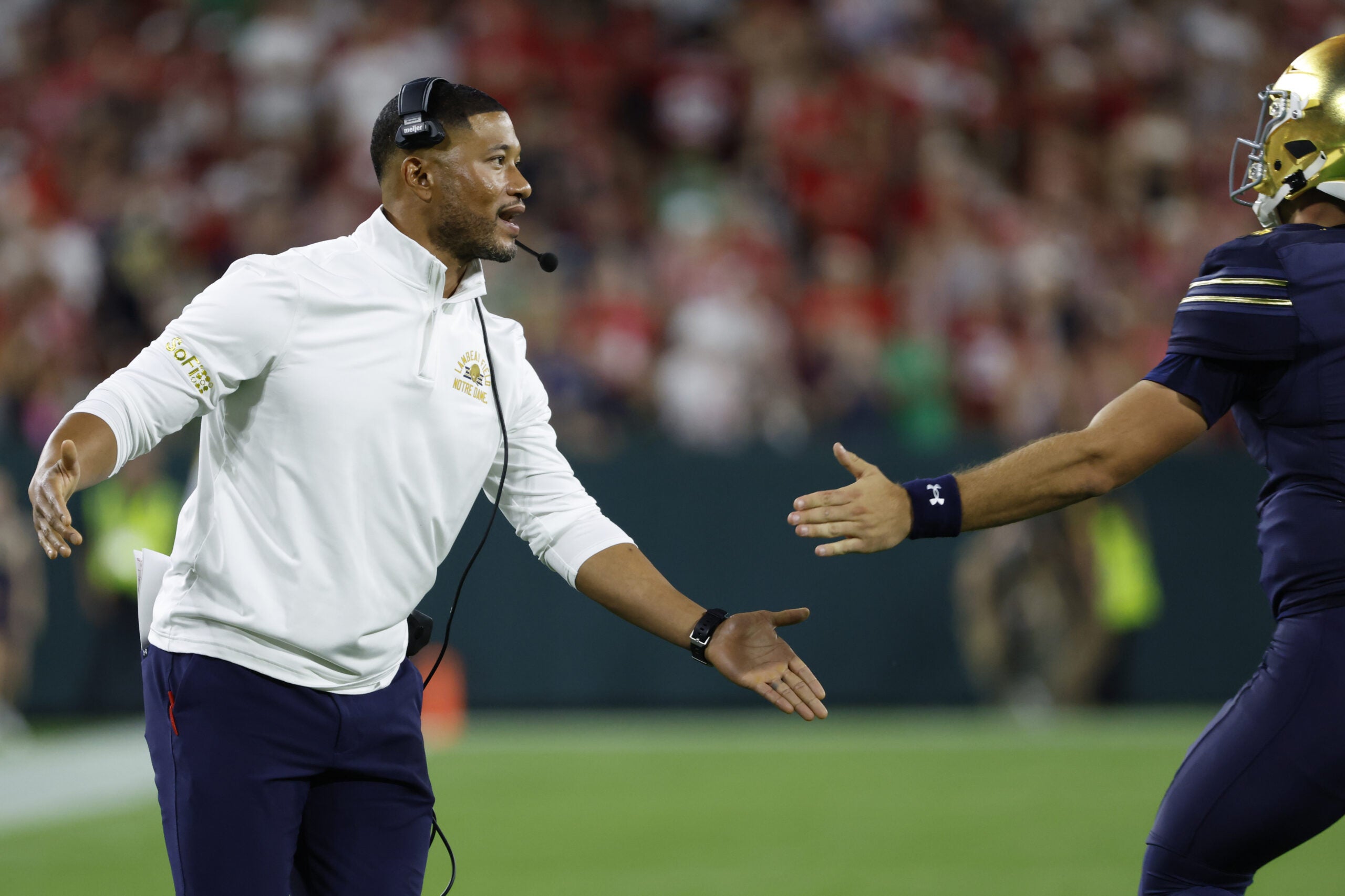 Sep 6, 2026; Green Bay, Wisconsin, USA; Notre Dame Fighting Irish head coach Marcus Freeman reacts in the first half at Lambeau Field.