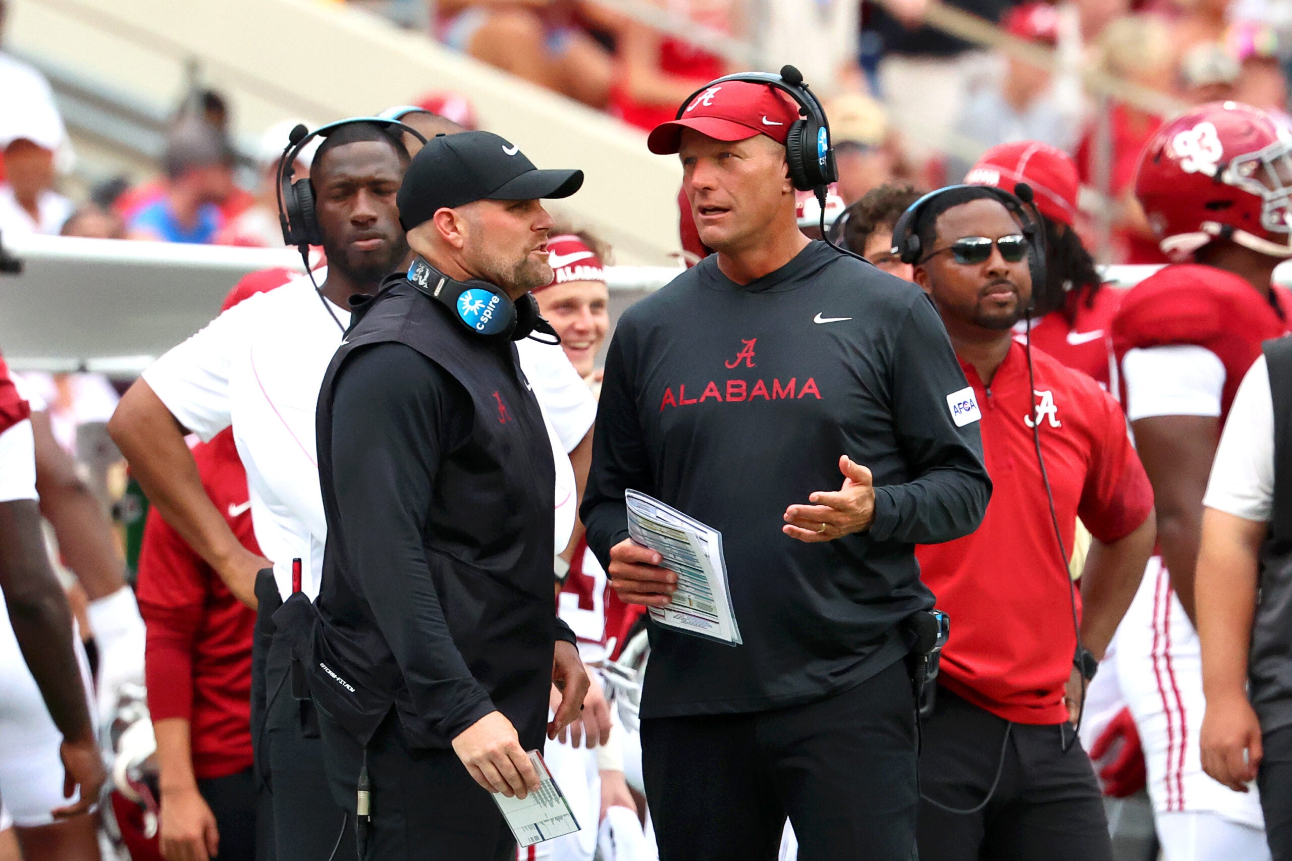 Sep 5, 2026; Tuscaloosa, Alabama, USA; Alabama Crimson Tide head coach Kalen DeBoer (right) talks with an assistant during the second quarter against the East Carolina Pirates at Saban Field at Bryant-Denny Stadium.