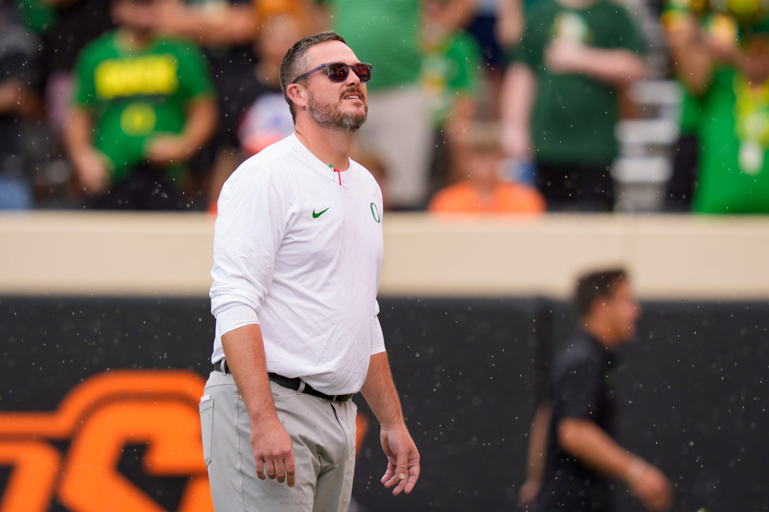 Oregon head coach Dan Lanning takes in the rain as the Oregon Ducks face the Oklahoma State Cowboys on Sept. 12, 2026, at Boone Pickens Stadium in Stillwater, Oklahoma.