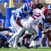 Kentucky Wildcats defensive lineman Mi'quise Humphrey-Grace (90) hits Alabama Crimson Tide quarterback Keelon Russell (12) to cause a Tide fumble and Cat recover in the first half Saturday, Sept. 12, 2026 in Lexington, Kentucky.