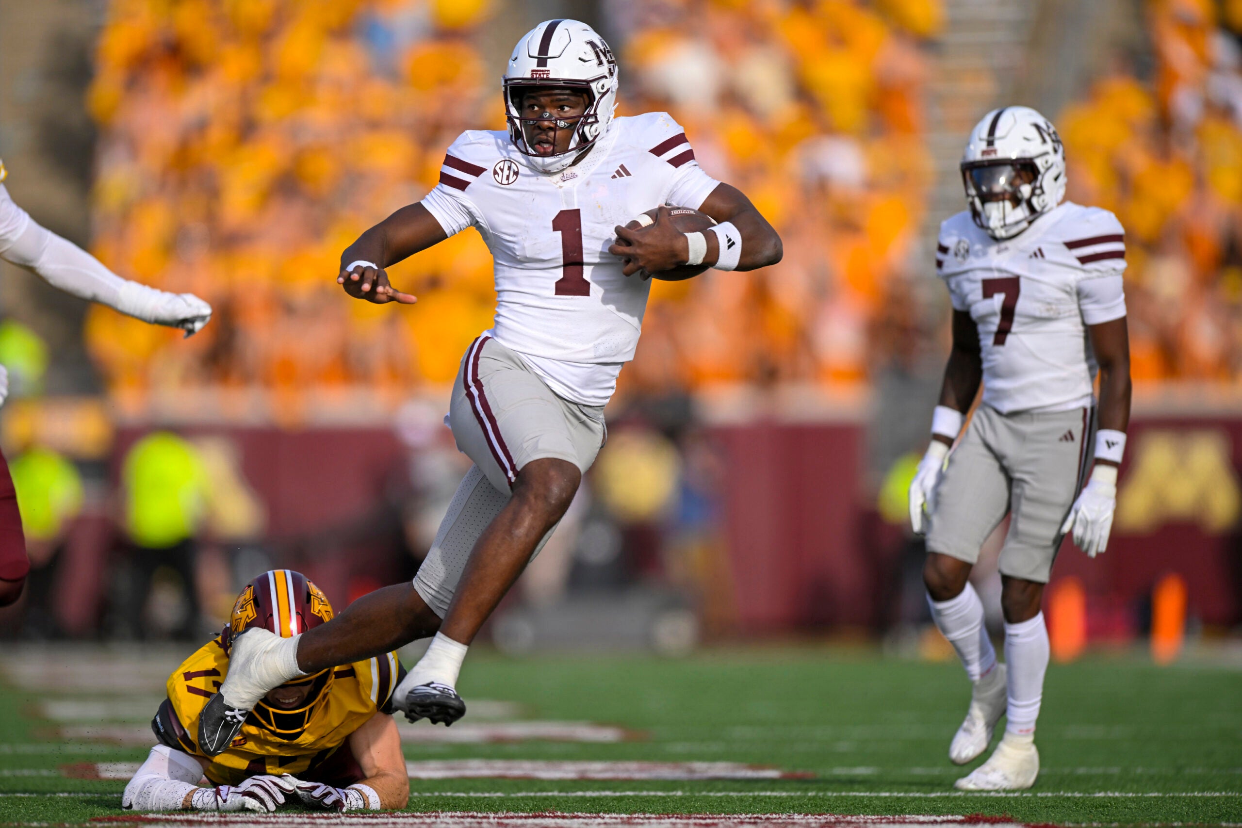 Sep 12, 2026; Minneapolis, Minnesota, USA; Mississippi State Bulldogs quarterback Kamario Taylor (1) breaks the tackle attempt of Minnesota Golden Gophers defensive back John Nestor (17) during the fourth quarter at Huntington Bank Stadium.