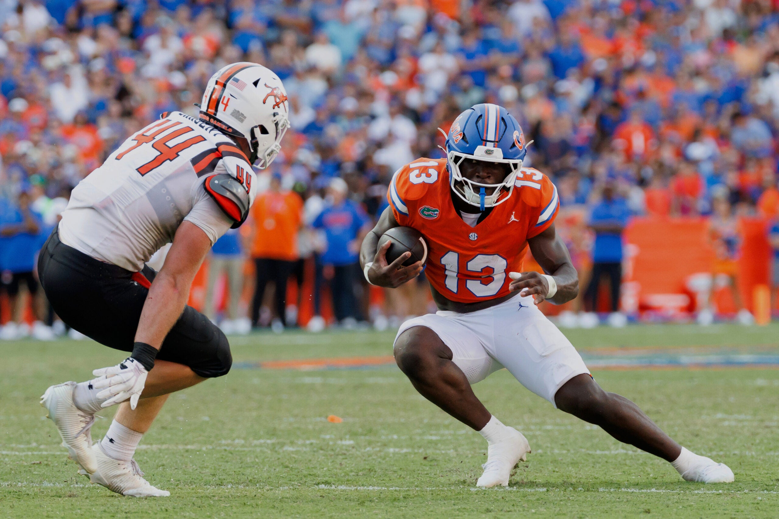 Sep 12, 2026; Gainesville, Florida, USA; Florida Gators running back Jadan Baugh (13) runs the ball against Campbell Fighting Camels linebacker Landon Sargent (44) during the first half at Ben Hill Griffin Stadium.