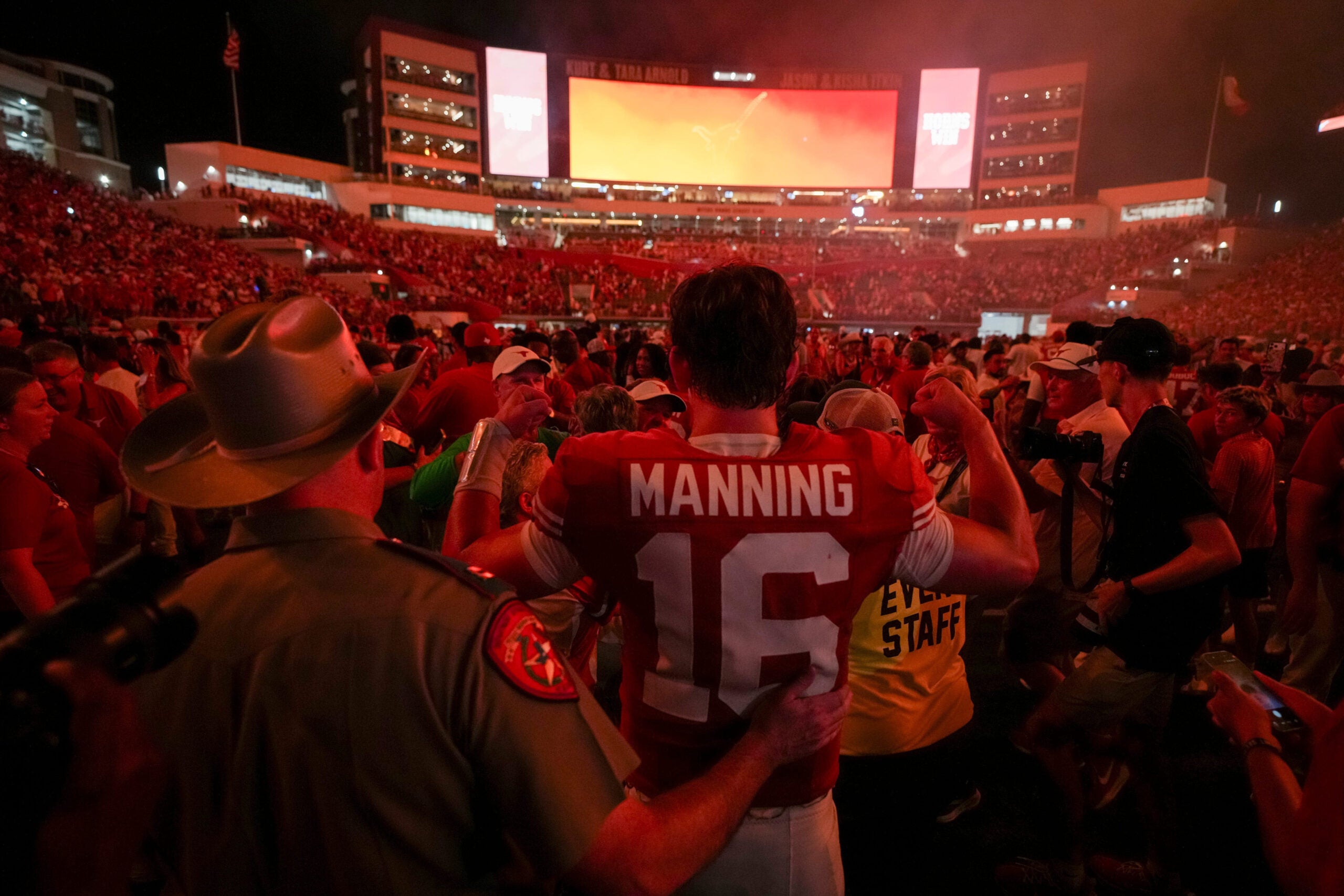 Fans celebrate with Texas quarterback Arch Manning (16) after the team's defeat of Ohio State at Darrell K Royal-Texas Memorial Stadium in Austin, Texas on Sept. 12, 2026.