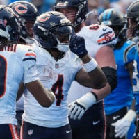 Sep 13, 2026; Charlotte, North Carolina, USA; Chicago Bears running back D'Andre Swift (4) reacts after scoring a touchdown in the first quarter against against the Carolina Panthers at Bank of America Stadium.
