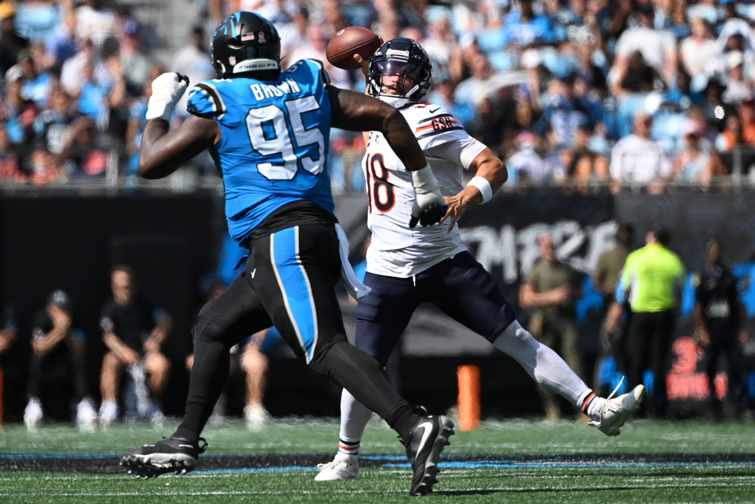 Sep 13, 2026; Charlotte, North Carolina, USA; Chicago Bears quarterback Caleb Williams (18) throws while pressured by Carolina Panthers defensive tackle Derrick Brown (95) in the third quarter at Bank of America Stadium.