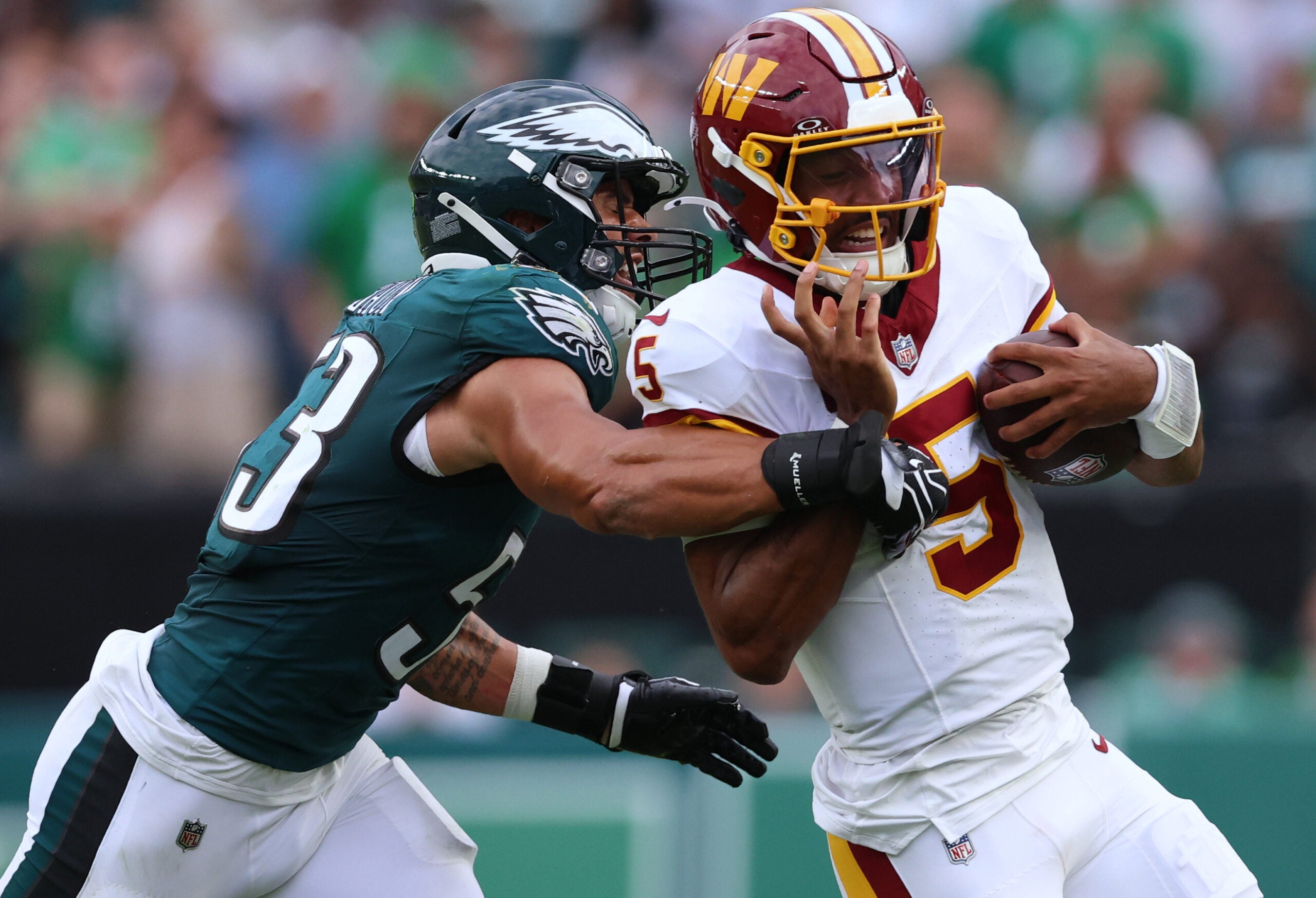 Sep 13, 2026; Philadelphia, Pennsylvania, USA; Washington Commanders quarterback Jayden Daniels (5) runs the ball against Philadelphia Eagles linebacker Zack Baun (53) during the first half at Lincoln Financial Field.