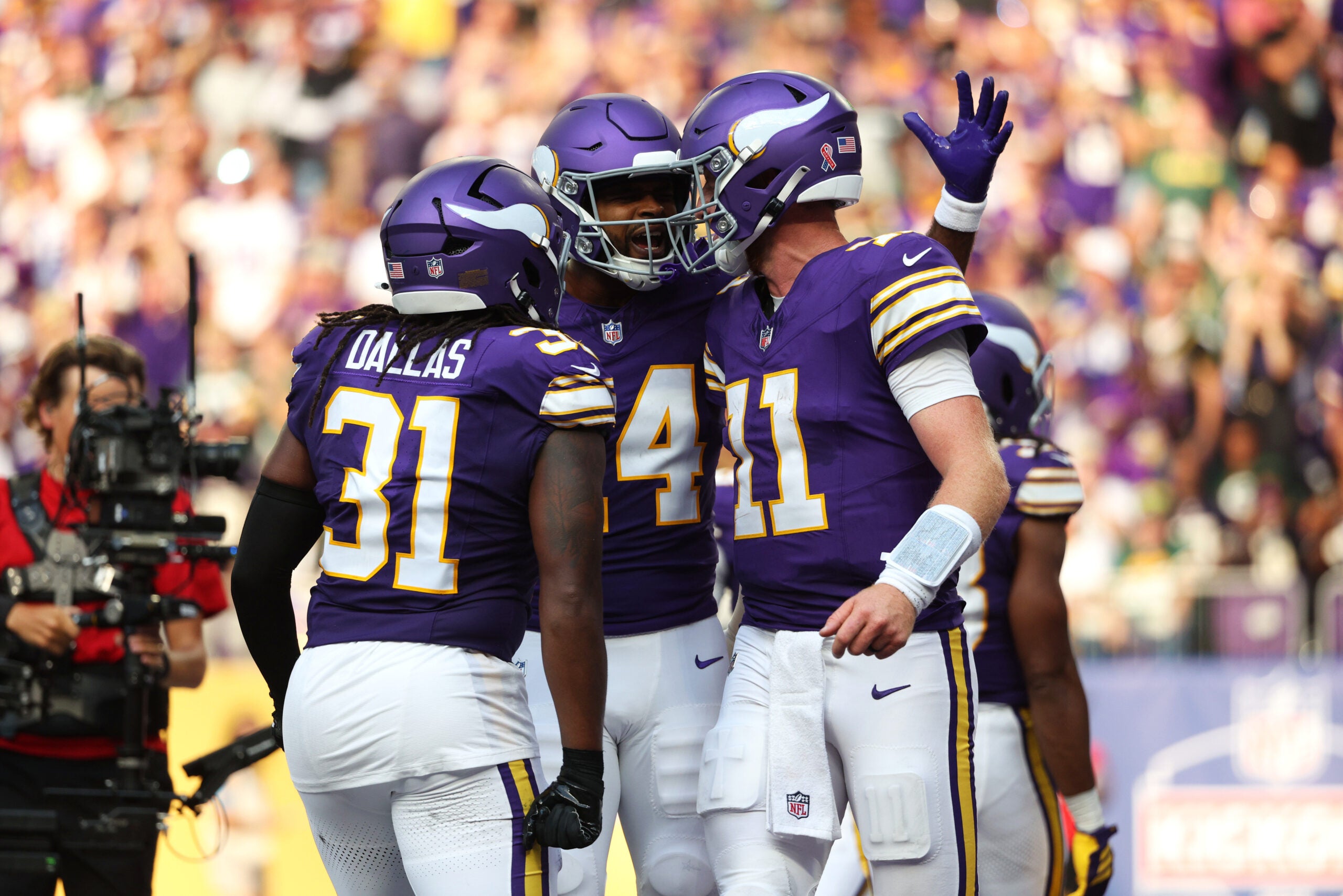 Sep 13, 2026; Minneapolis, Minnesota, USA; Minnesota Vikings quarterback Carson Wentz (11) celebrates a touchdown during the first half against the Green Bay Packers at U.S. Bank Stadium.