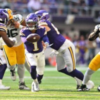 Sep 13, 2026; Minneapolis, Minnesota, USA; Minnesota Vikings quarterback Kyler Murray (1) runs for a pass against Green Bay Packers defensive tackle Devonte Wyatt (95) during the second half at U.S. Bank Stadium.