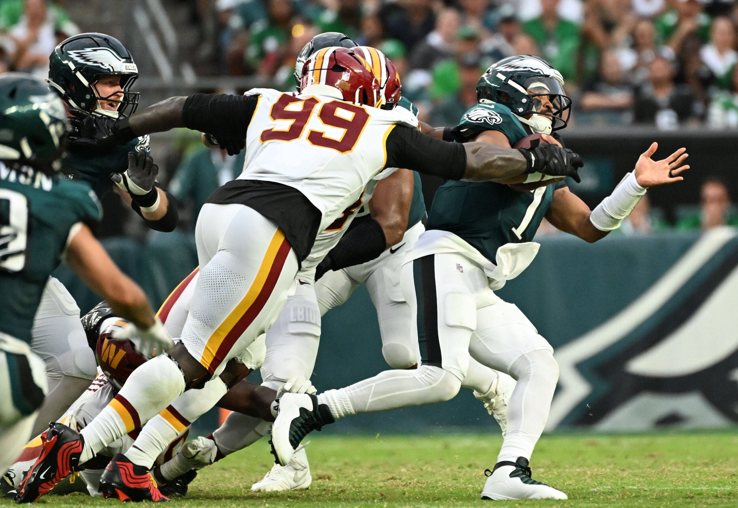 Sep 13, 2026; Philadelphia, Pennsylvania, USA; Washington Commanders defensive tackle Javon Kinlaw (99) sacks Philadelphia Eagles quarterback Jalen Hurts (1) during the second half at Lincoln Financial Field.