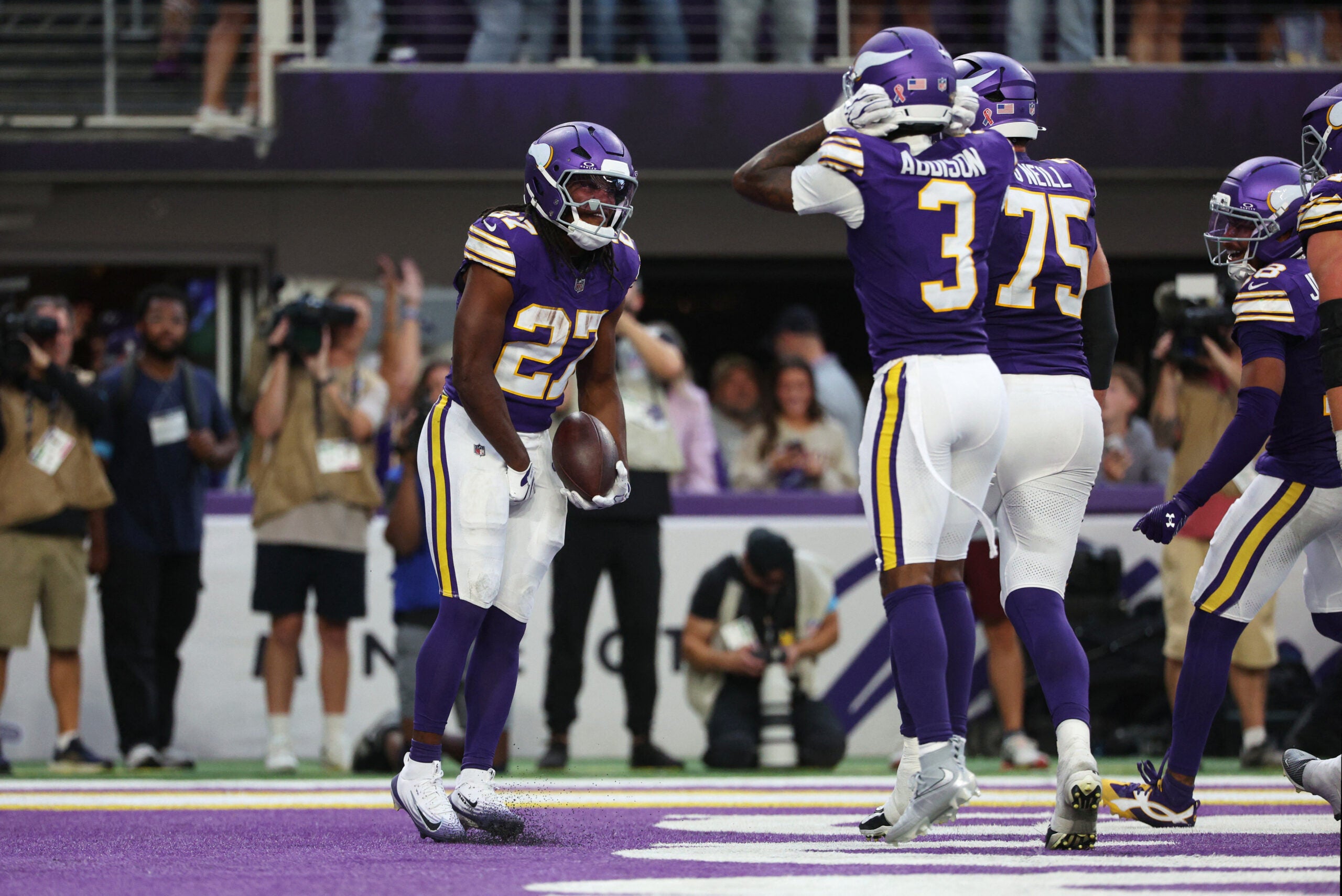Sep 13, 2026; Minneapolis, Minnesota, USA; Minnesota Vikings running back Jordan Mason (27) celebrates after a touchdown during the second half against the Green Bay Packers at U.S. Bank Stadium.