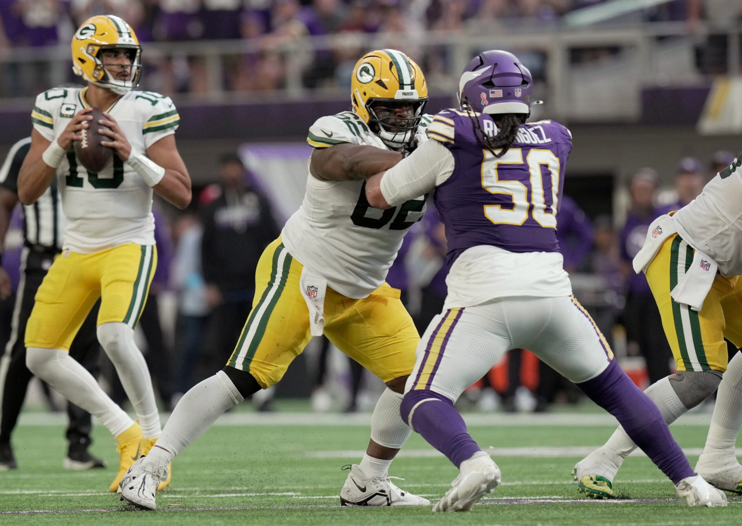 Green Bay Packers center Jacob Monk (62) blocks Minnesota Vikings defensive tackle Levi Drake Rodriguez (50) while quarterback Jordan Love (10) drops back to pass during the fourth quarter of their game Sunday, Sept. 13, 2026 at U.S. Bank Stadium in Minneapolis, Minnesota. The Minnesota Vikings beat the Green Bay Packers 39-22.