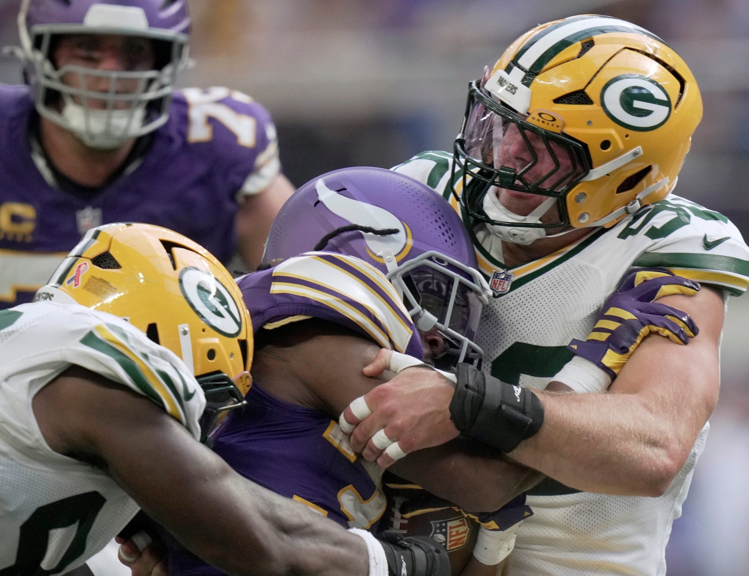 Green Bay Packers defensive end Lukas van Ness (90) stuffs Minnesota Vikings running back Aaron Jones Sr. (33) at the line during the second quarter of their game Sunday, Sept. 13, 2026 at U.S. Bank Stadium in Minneapolis, Minnesota.