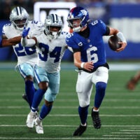 Sep 13, 2026; East Rutherford, New Jersey, USA; New York Giants quarterback Jaxson Dart (6) scrambles with the ball defended by Dallas Cowboys safety Jalen Thompson (34) during the first quarter at MetLife Stadium.