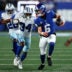 Sep 13, 2026; East Rutherford, New Jersey, USA; New York Giants quarterback Jaxson Dart (6) scrambles with the ball defended by Dallas Cowboys safety Jalen Thompson (34) during the first quarter at MetLife Stadium.